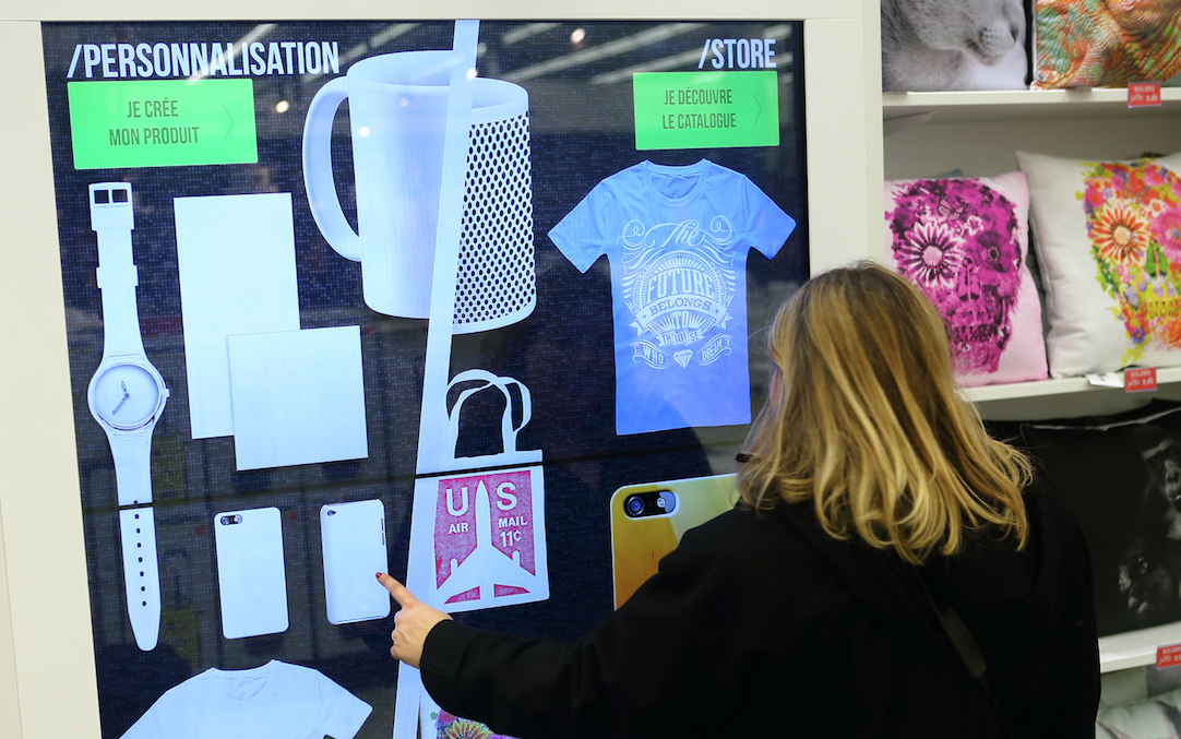 Woman using mydesign.com in Carrefour shop