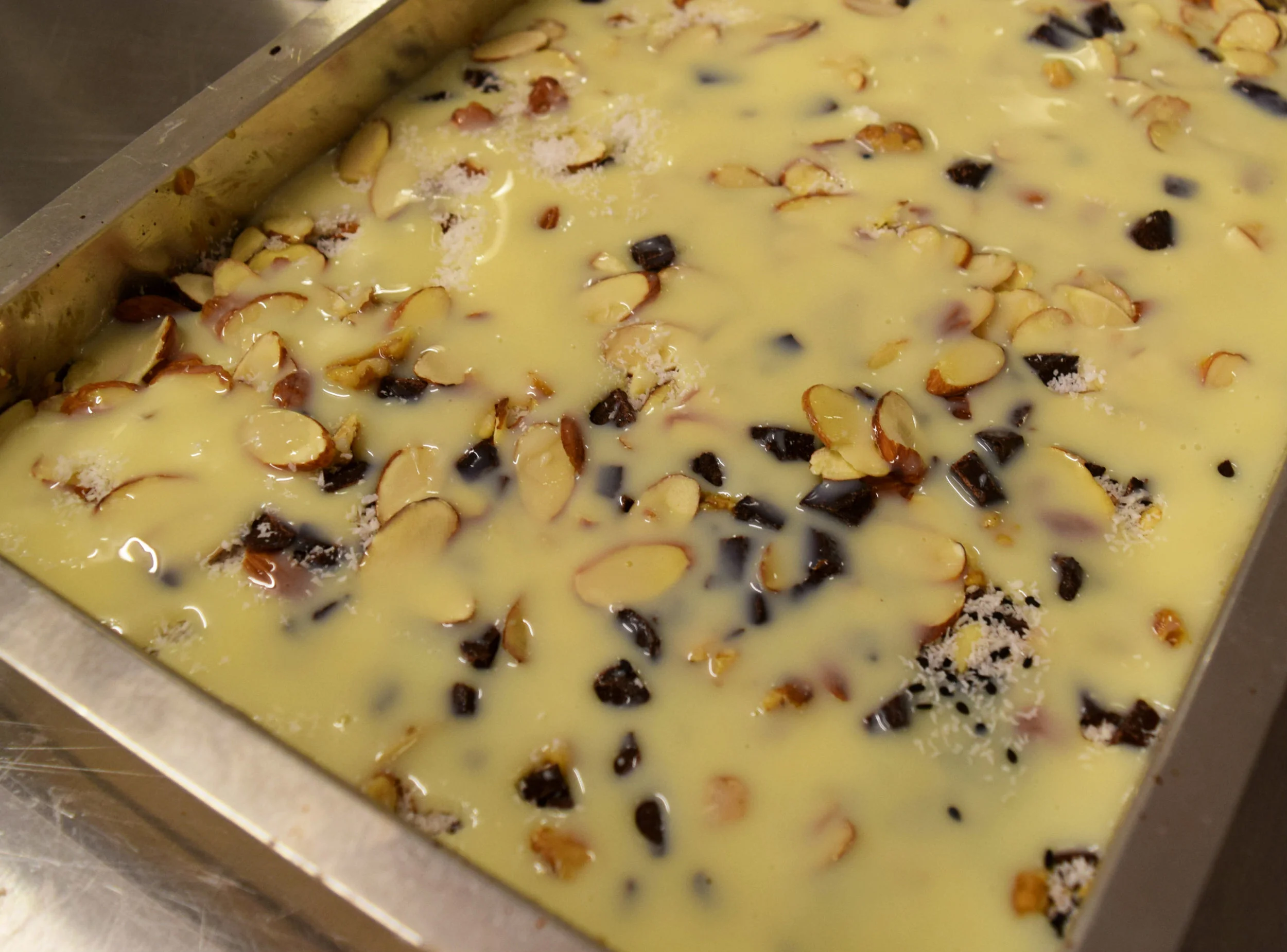 A pan of 8 Treasures Bars right before they go in the oven.