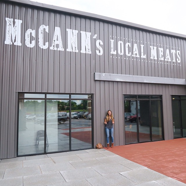 Standing in front of McCann's Local Meats all-in-one butcher shop, deli, and sandwich stop!