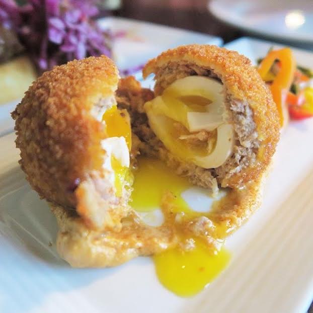 Scotch Egg = Soft boiled egg wrapped in their house sausage with pickled veg & deep-fried.