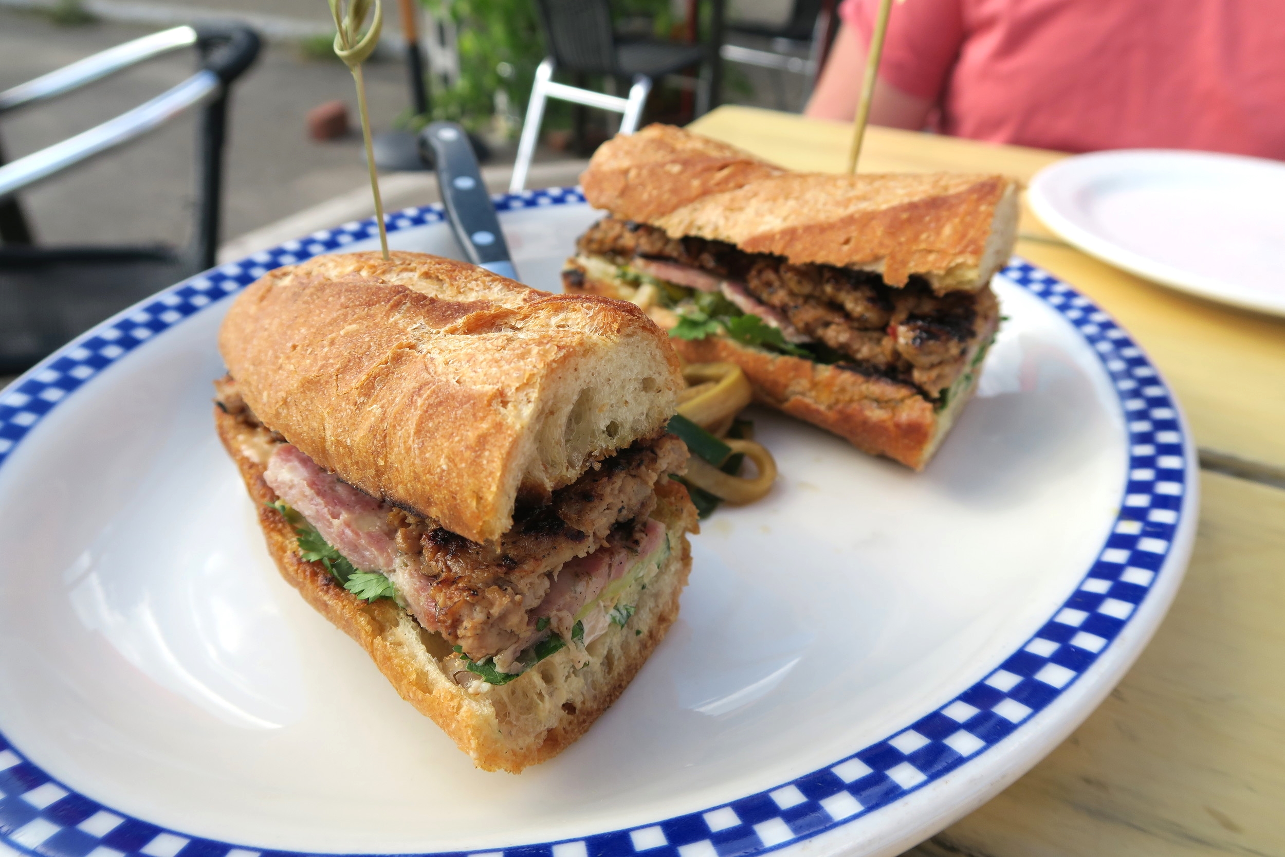 Cure's Banh Mi is served on a toasted baguette from Flour City and made with pork sausage, pate, pickled vegetables, a house made spice mayo, with a cucumber salad $16