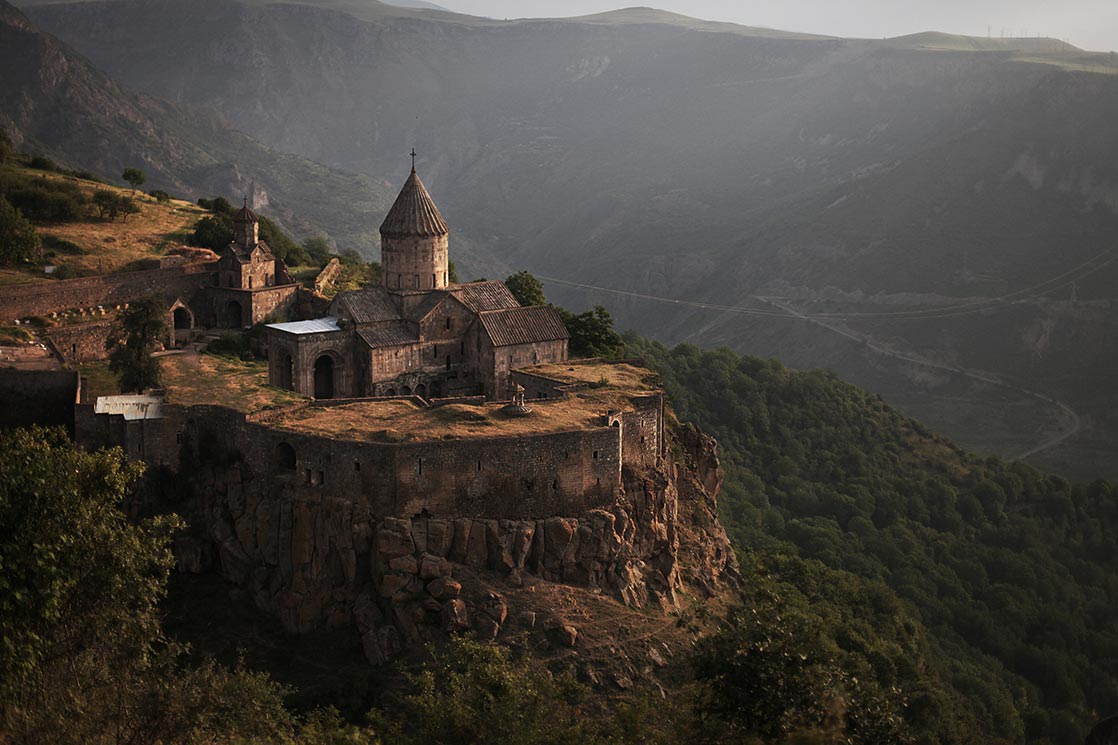 Tatev is a 9th-century monastery located on a large basalt plateau in southeastern of Armenia . The term "Tatev" usually refers to the monastery. The monastic ensemble stands on the edge of a deep gorge of the Vorotan River