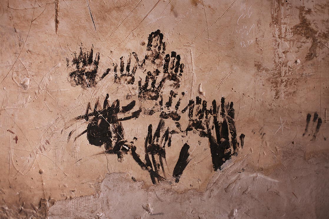 Black fingerprints and red wall