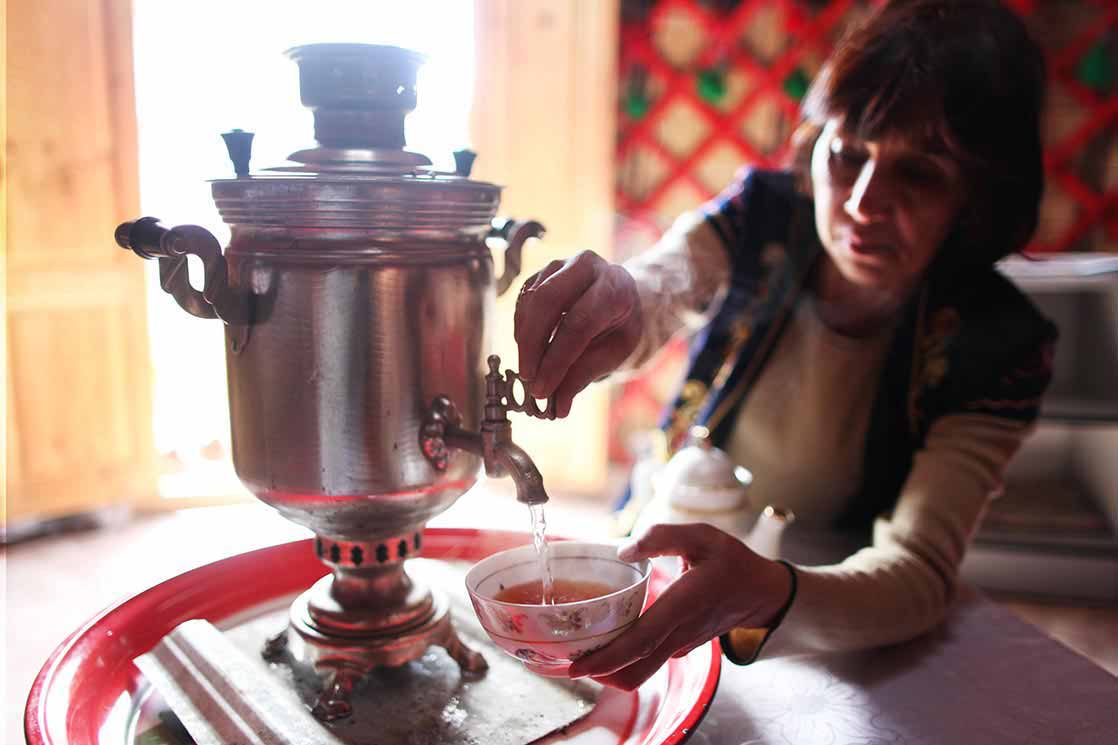 The woman in the yurt uses a Samovar to boil water, which is typically used to make tea in Central Asia and Russia | KYRGYZSTAN