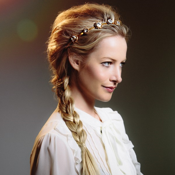 Pretty In Plaits Keep things pretty and festive with a ruffled white blouse and pink lips. Step 1: Prep the hair with a volumizing dry shampoo to get maximum texture from roots to ends. Step 2: Tease at the crown and gently smooth the top layer. Step 3: Braid hair to one side, pin any loose ends and spritz with a strong-hold finishing spray. Step 4: Accessorize with the headband .