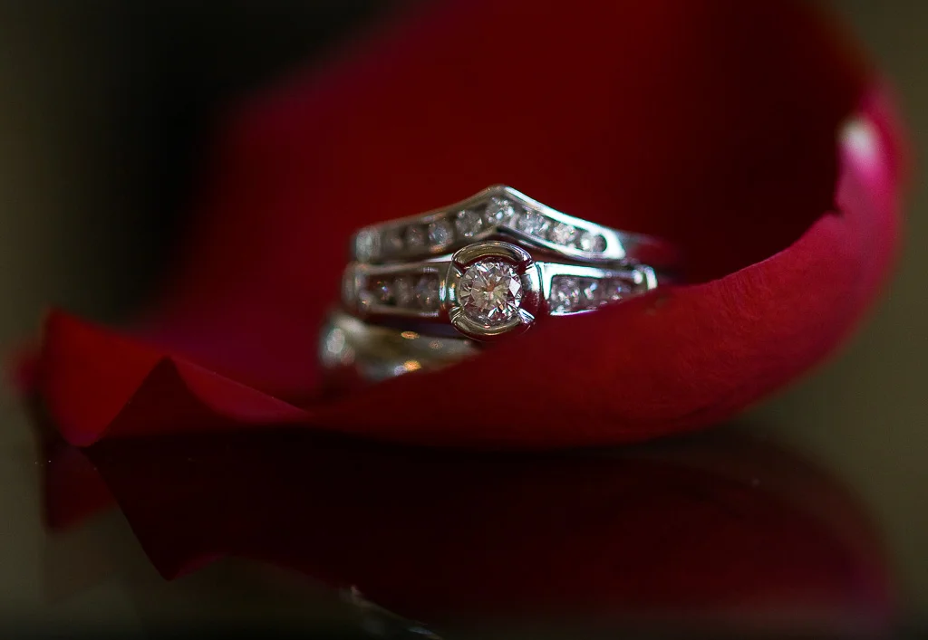 Photograph of wedding rings in rose petal