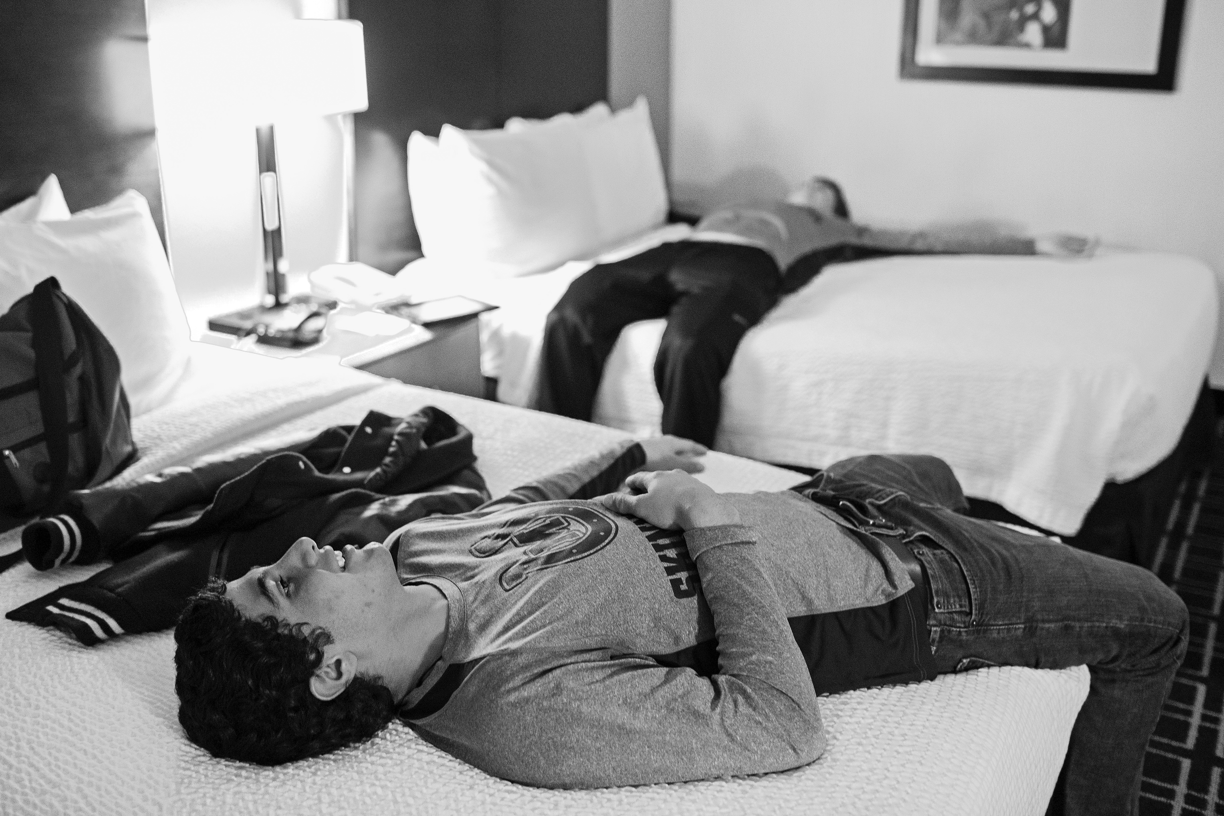 Miguel Castillo and Garret Bibb, his roommate for the night, test the beds in the team hotel on Dec. 17, 2014 in Arlington, Texas. While both brothers dream of attending the Naval Academy, Miguel would seem to be a step closer to the dream after attending the Academy's Summer Seminar program for high school seniors, in which he excelled. "They even put him in charge of the other students, he came back so happy," said his proud mother.