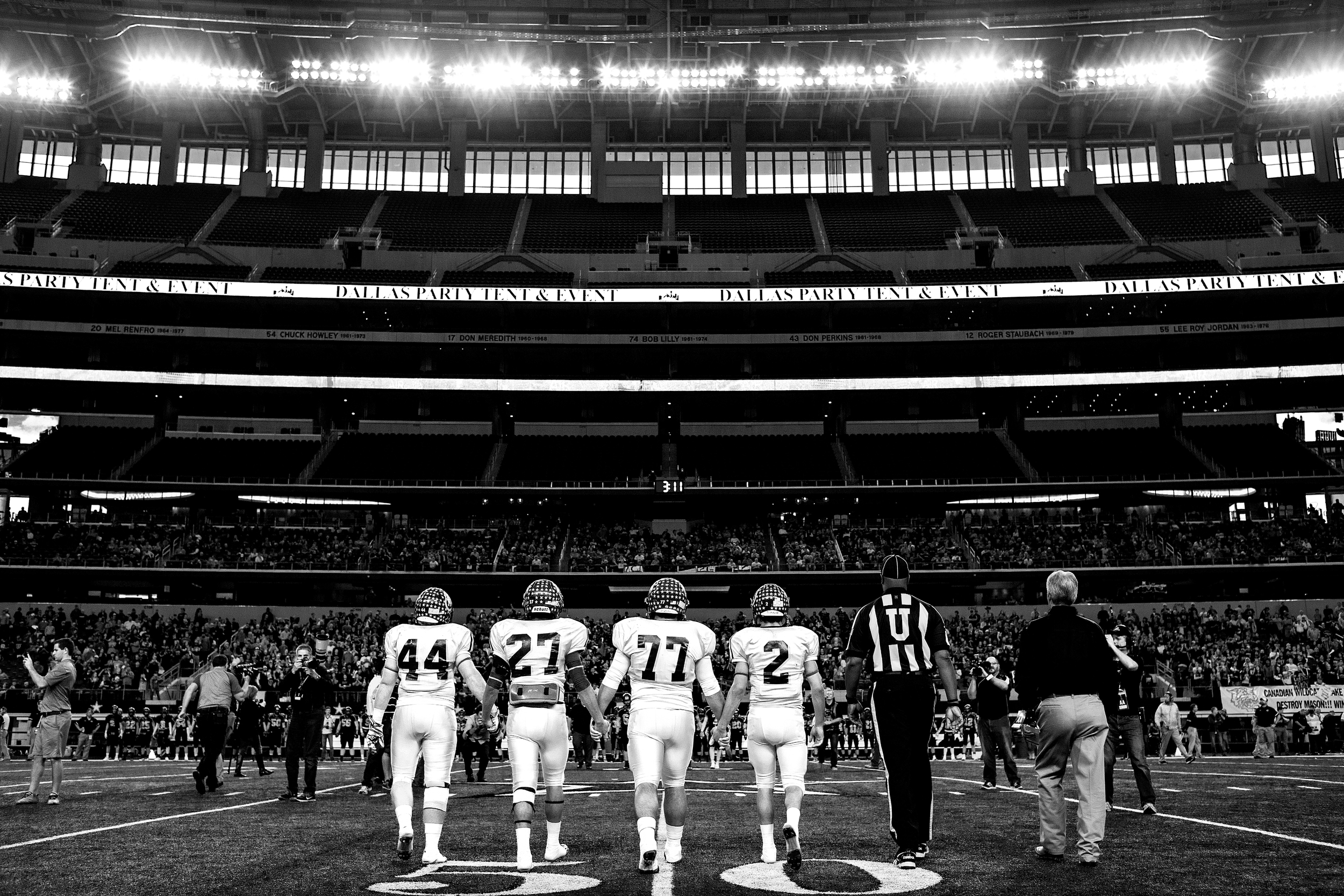 Mason Punchers seniors and captains Rylee Owen (44), Luis Castillo (27), Kyle Zavala (77) and Miguel Castillo (2) walk towards midfield at AT&T Stadium in Arlington, Texas on Dec. 18, 2014 for the Texas 2A State Championship Game coin toss. Luis and Miguel grew up very close to Owen and Zavala, and all four have played together throughout their high school careers.