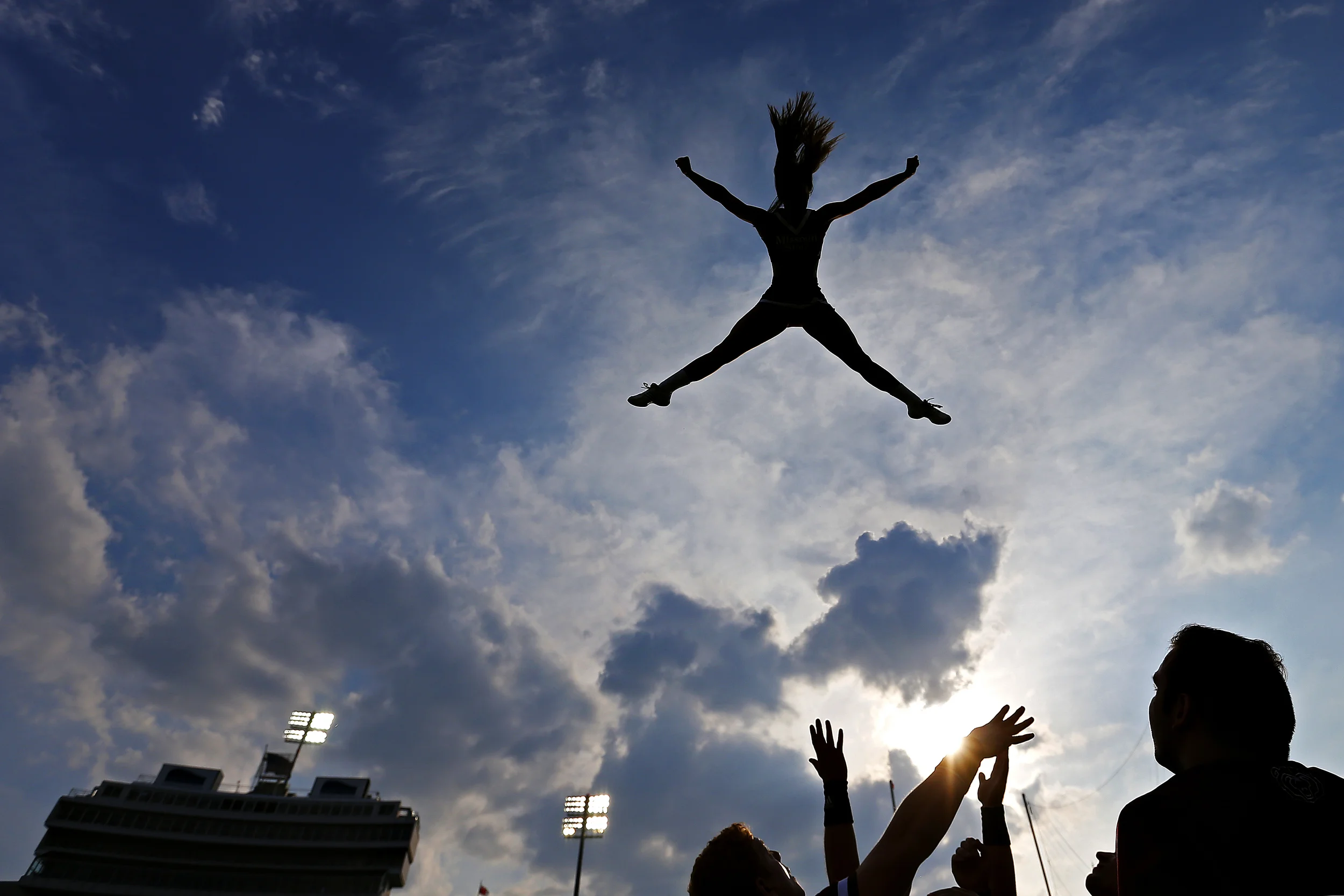 Missouri State University cheerleader Lacey Bertram flies up in the air during a stunt prior to the start of the Bears' season opener game against the Memphis Tigers at the Liberty Bowl Memorial Stadium in Memphis, Tenn. on Sep. 5, 2015. The Tigers won the game 63-7.