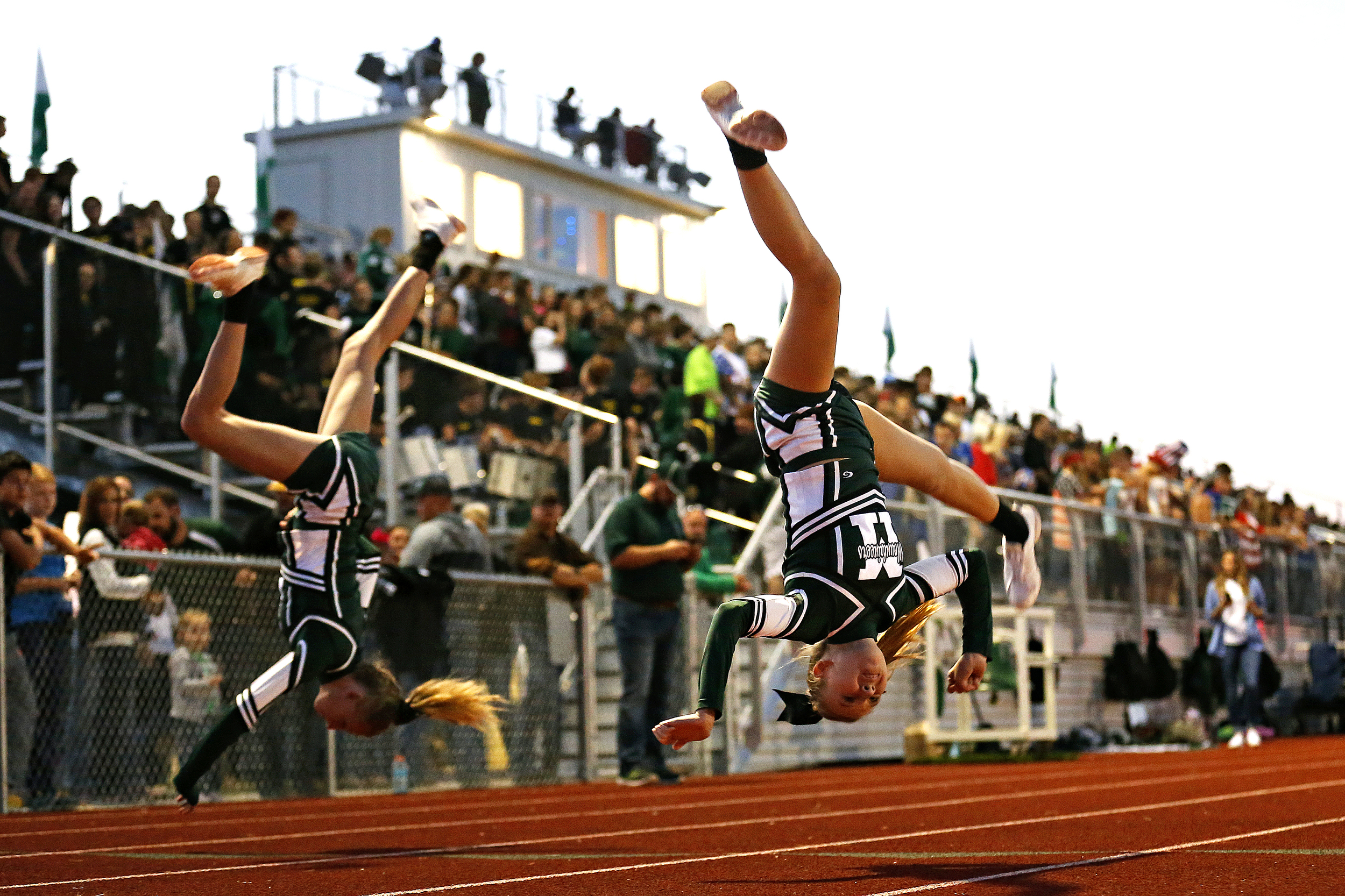 Mt. Vernon Junior High cheerleaders Jordan Downey (right) and Sadie Heisner do a flip after a Mountaineers score during first quarter action of the high school football game between Mt. Vernon High School and Aurora High School at Mountaineer Stadium in Mt. Vernon, Mo. on Sept. 30, 2016. The Mt. Vernon Mountaineers won the game 42-28.