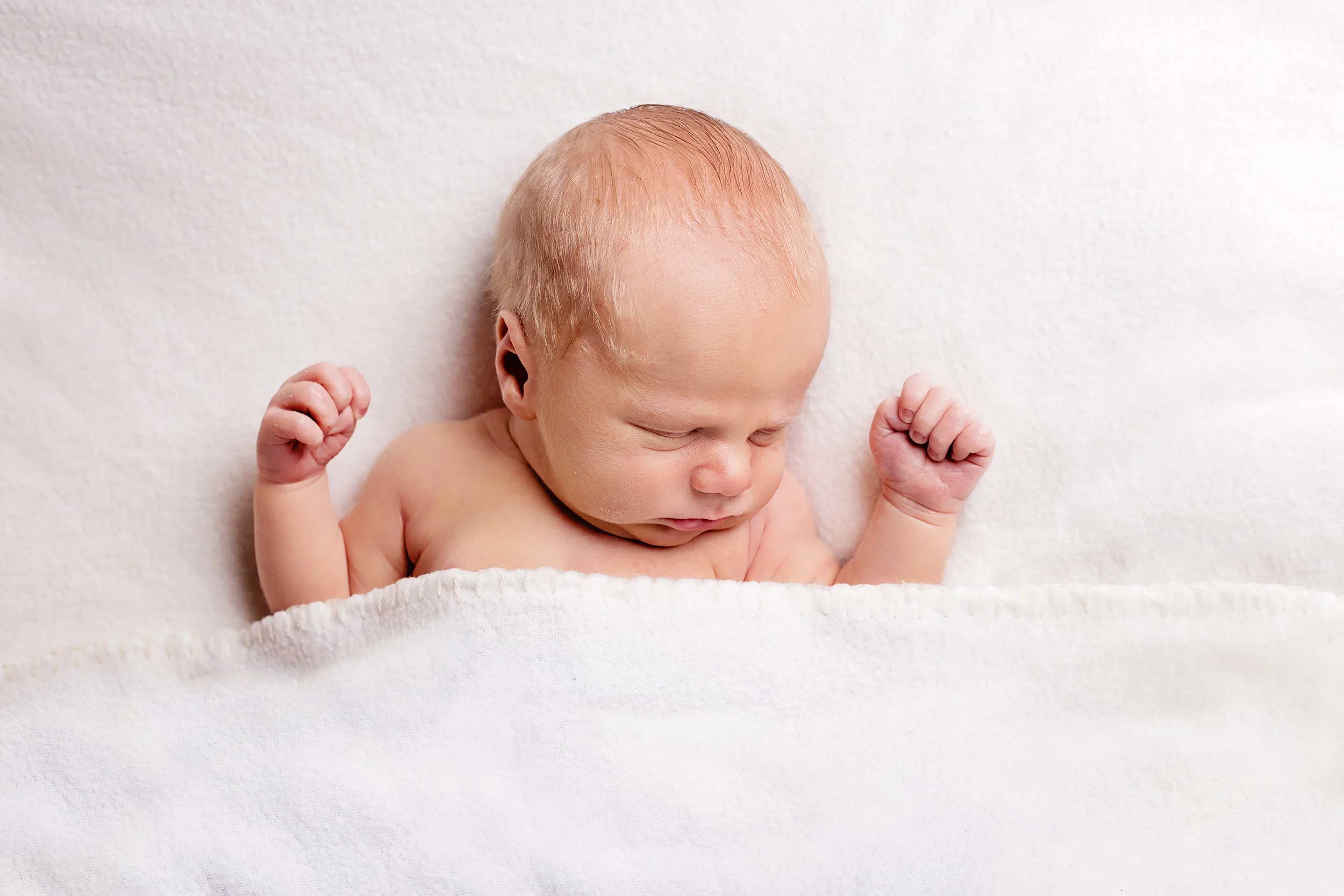 newborn baby in bed.jpg