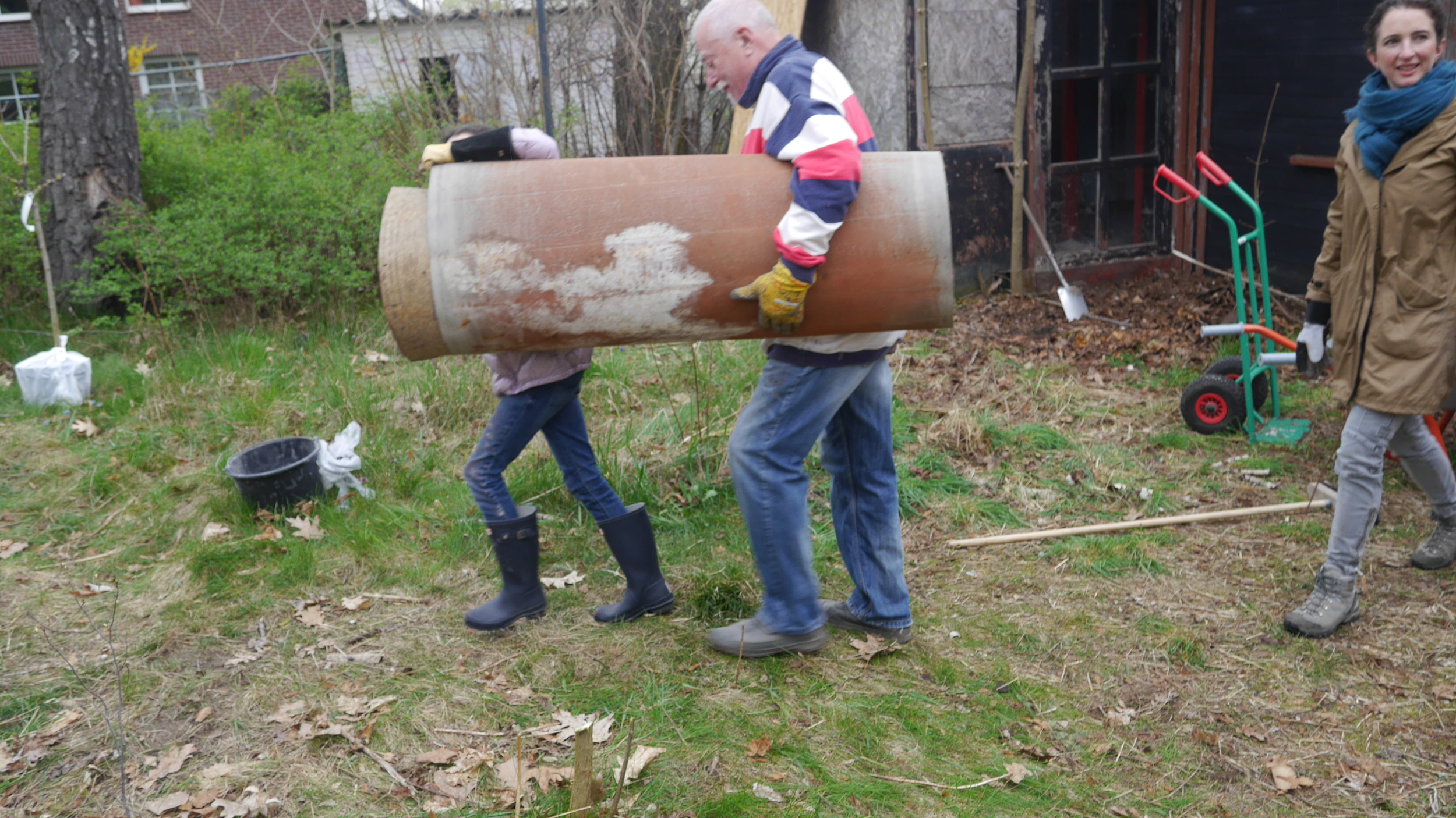 Eve and man carry blanket.JPG