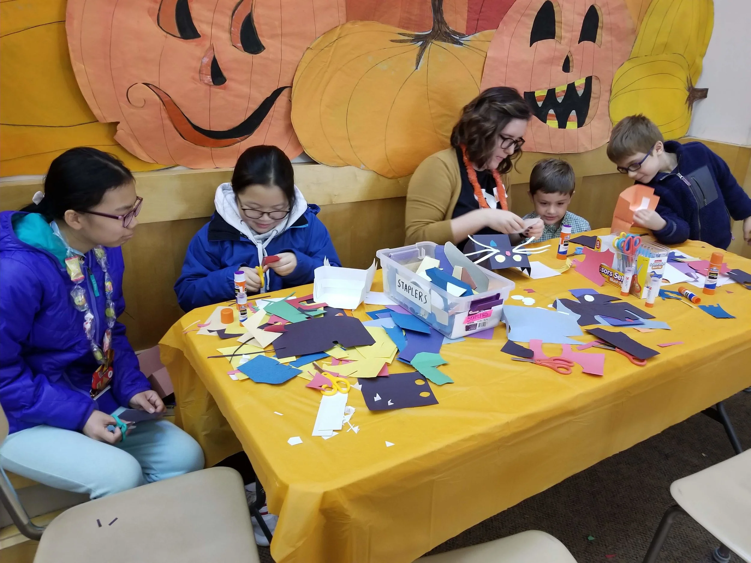 Box Office Associate Lakyn leading a puppet making craft at Lincoln School Pumpkinfest.