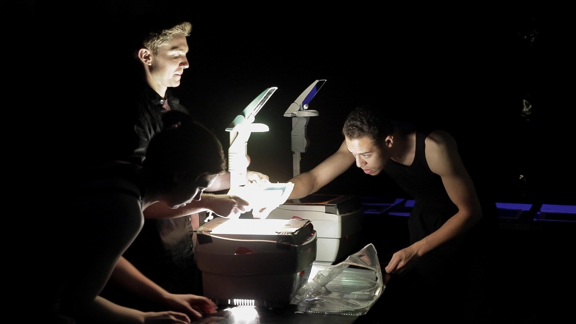 Max, Tony, and Jordan work with projectors.