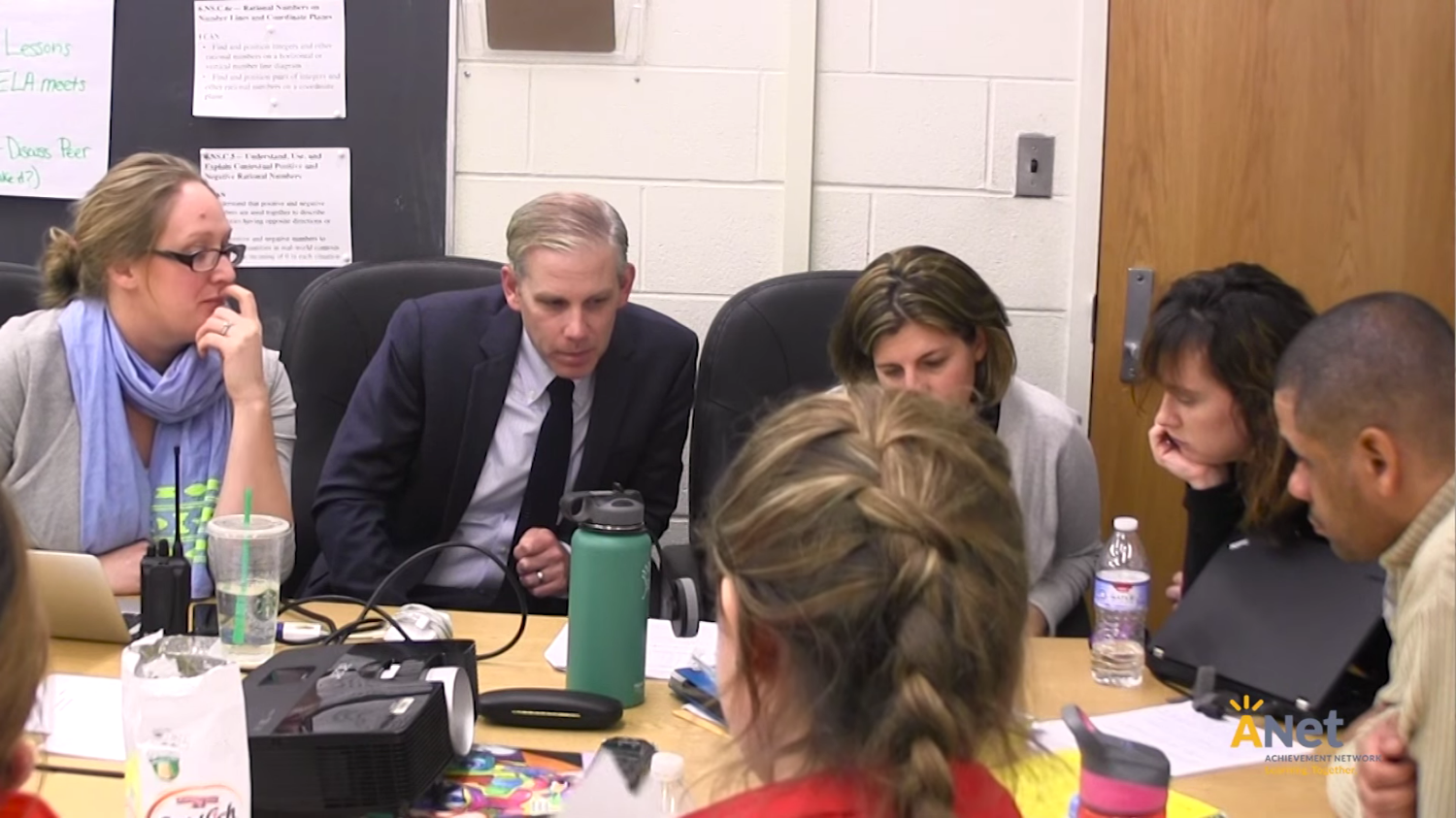 Photo of educational leaders collaborating around a big table