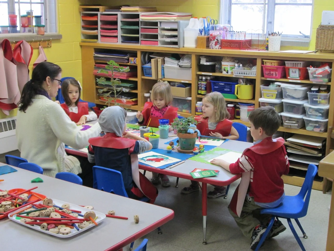 Mrs. Jones leads her small group of students through an expressive painting project in the Art Room.