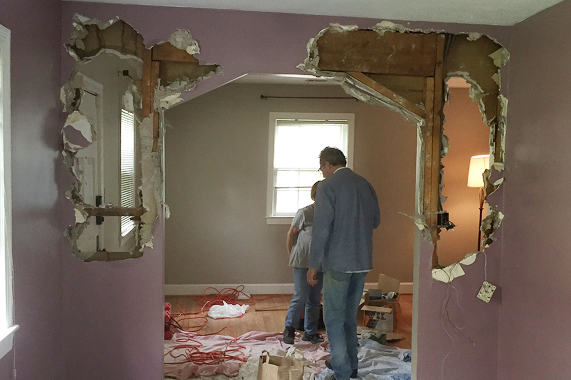 What looks like a large header is actually just backing for the plaster wall finish. There was an inch gap between that large piece of wood and the floor joists above, meaning there was no weight bearing on the wall.