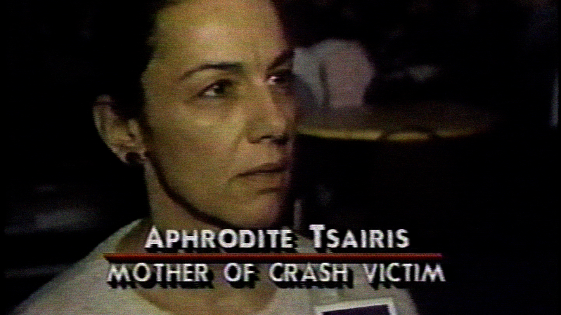 Aphrodite Tsairis, a former high school English and French teacher and crossword puzzle editor, devoted much of her time after the bombing to finding answers for the crime. She served as chair of the victims' group during the 1990s. Aphrodite Tsairis is interviewed by media at a meeting for Pan Am Flight 103 victim families one month after the bombing.