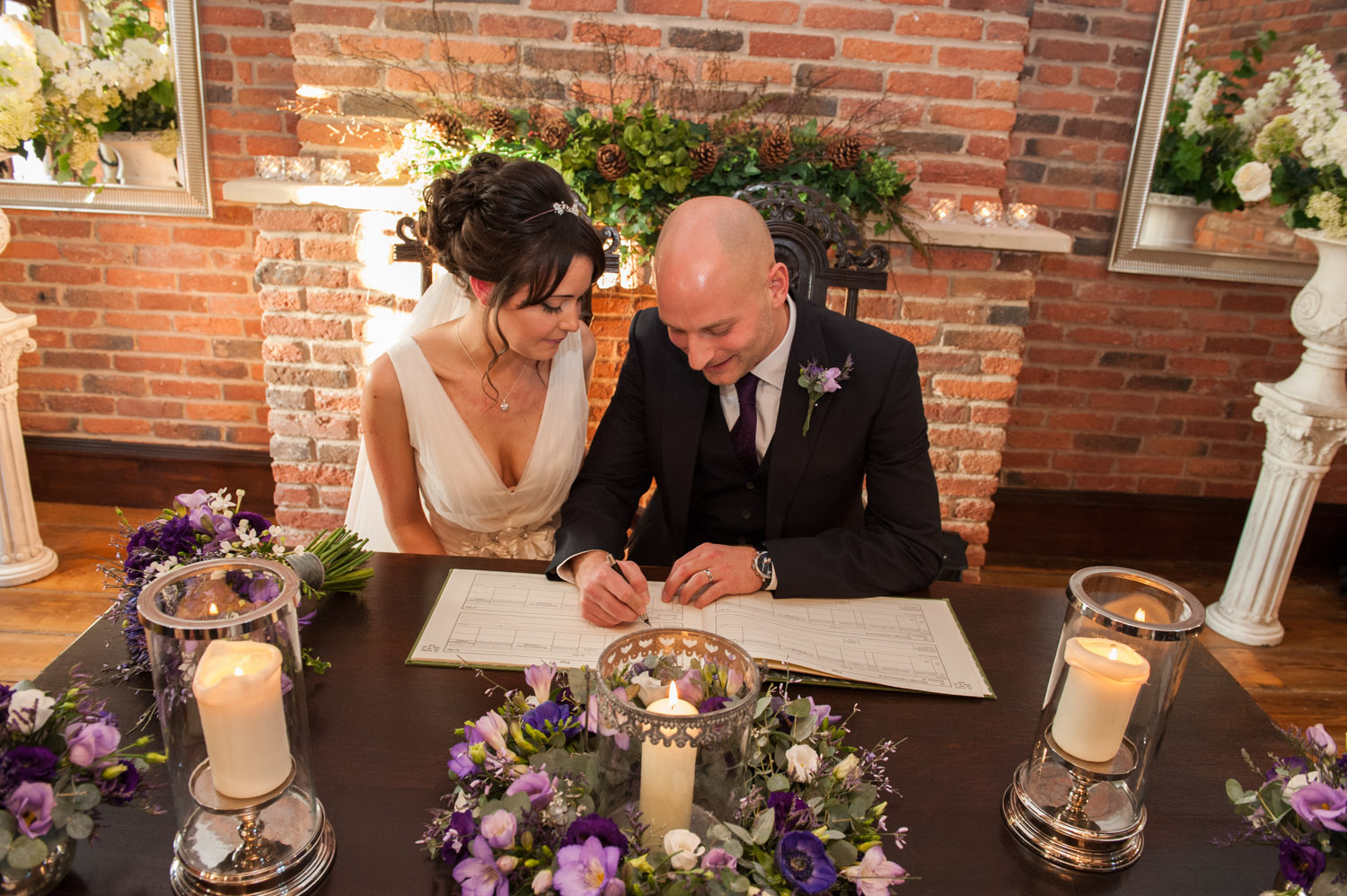 bride and grrom signing the register at Swancar Farm