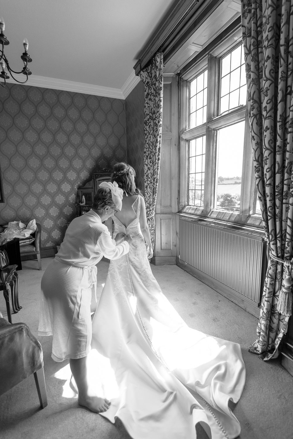 bride getting into her wedding dress at callow hall