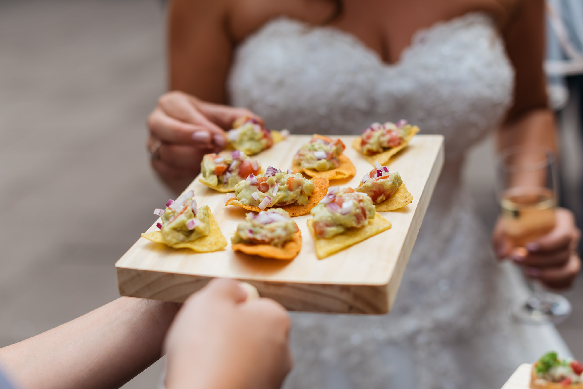 Bride eating canapes at Cloisters wedding in Oundle