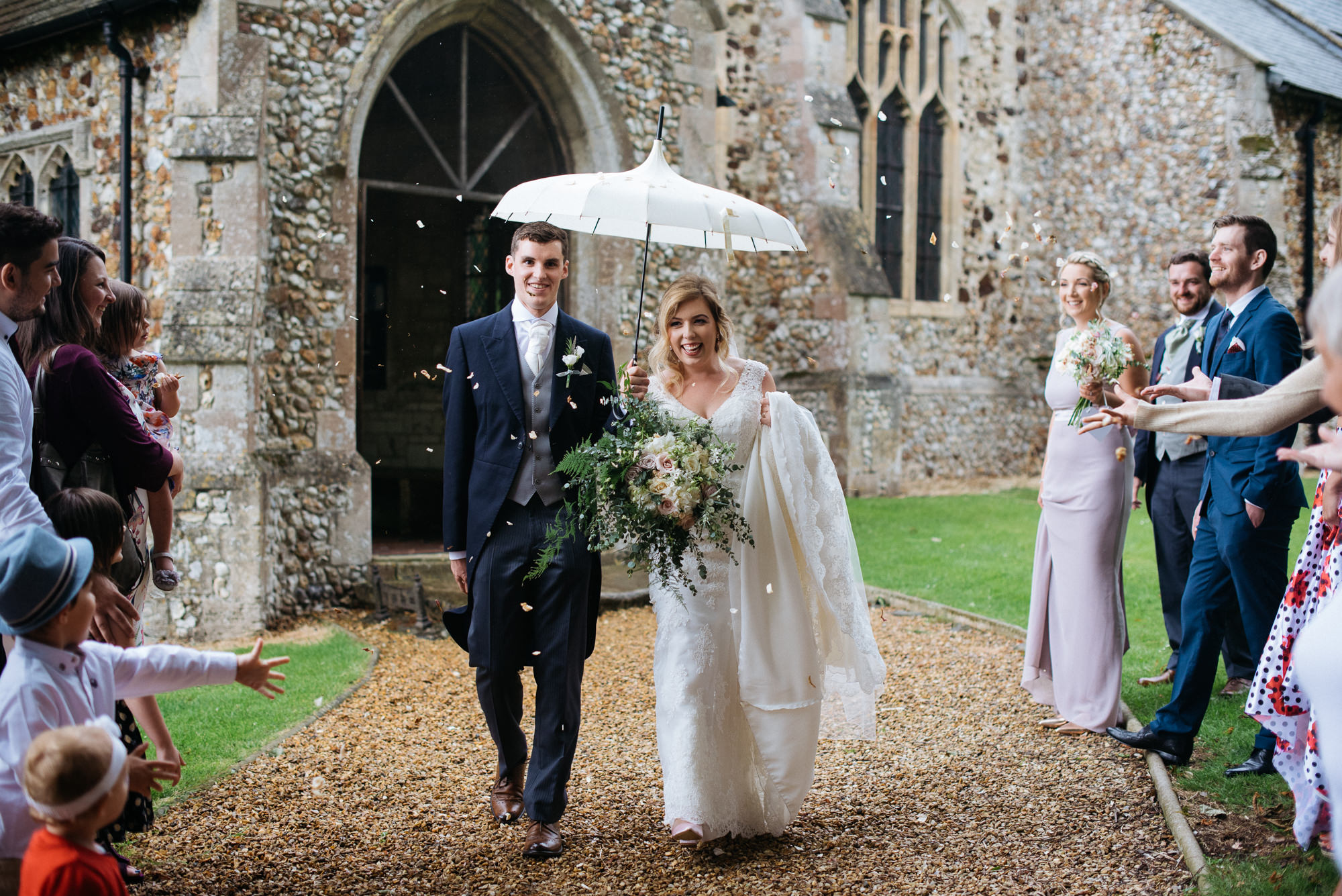 Bride and groom exit church narborough hall gardens wedding
