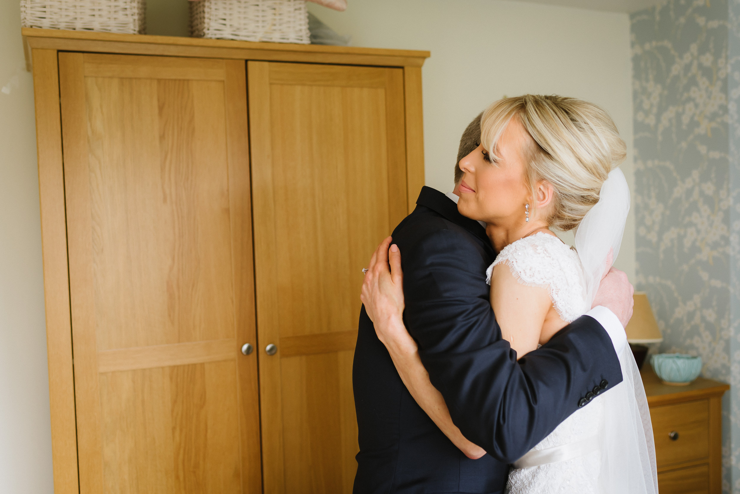 bride and her father having a hug