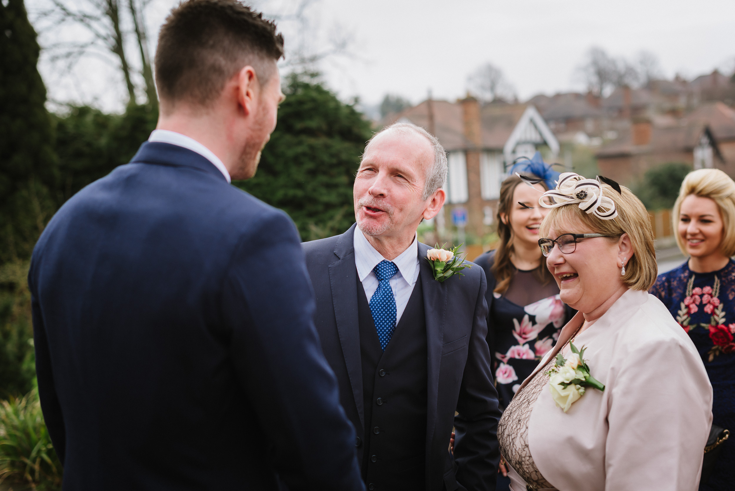 groom talks with wedding guests