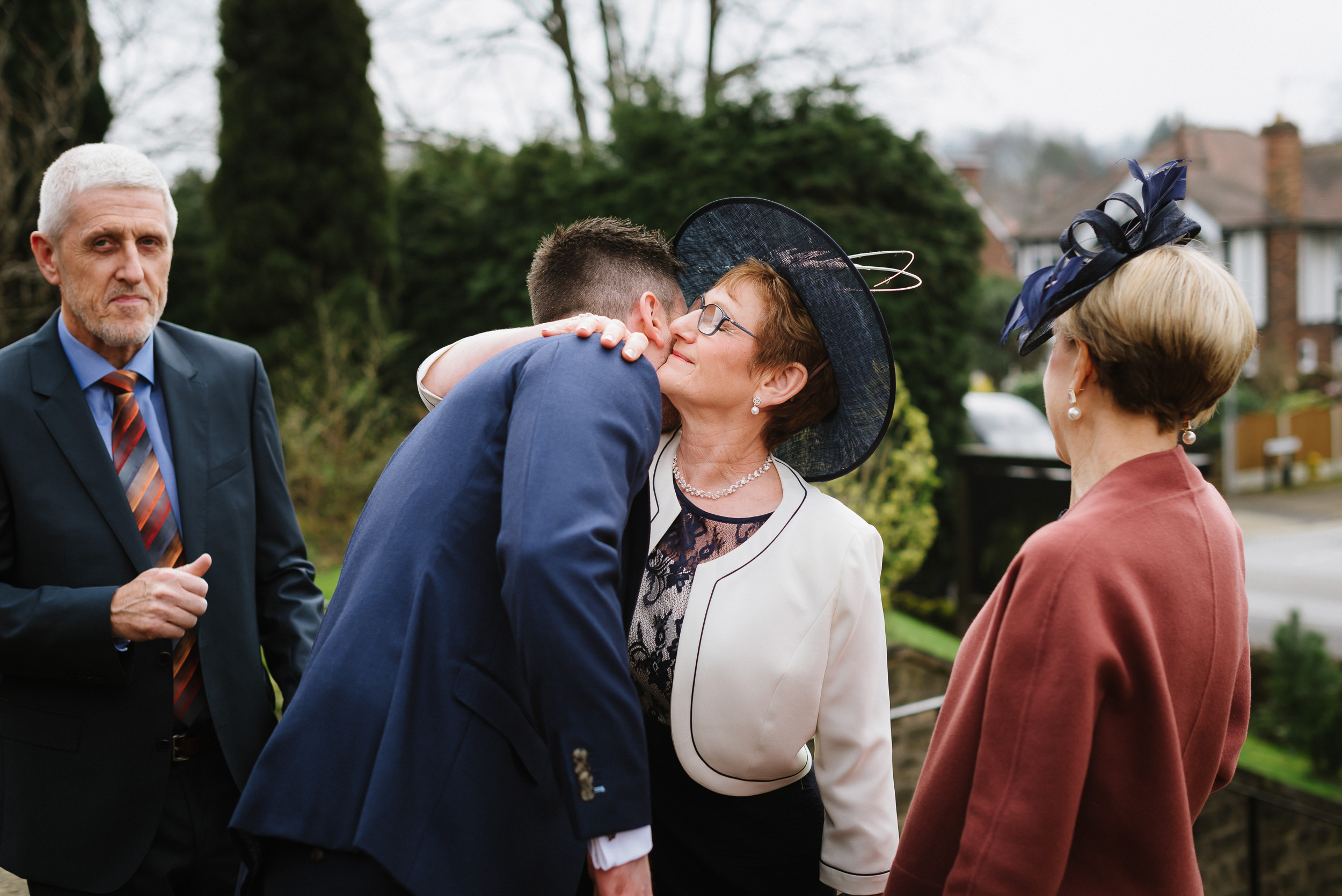 Groom and his mother having a hug