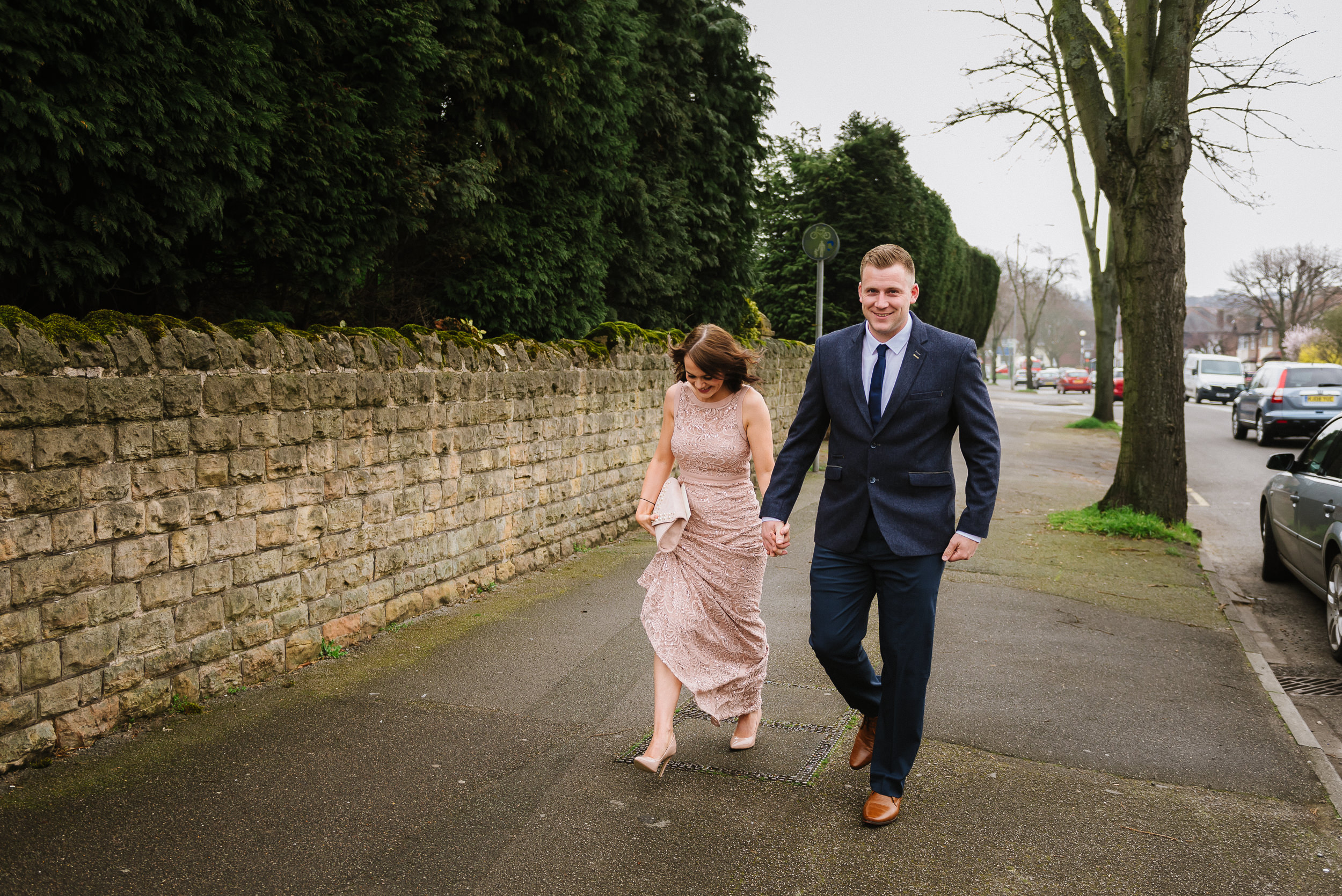 wedding guests arrive at Good Shepherd Church in Woodthorpe