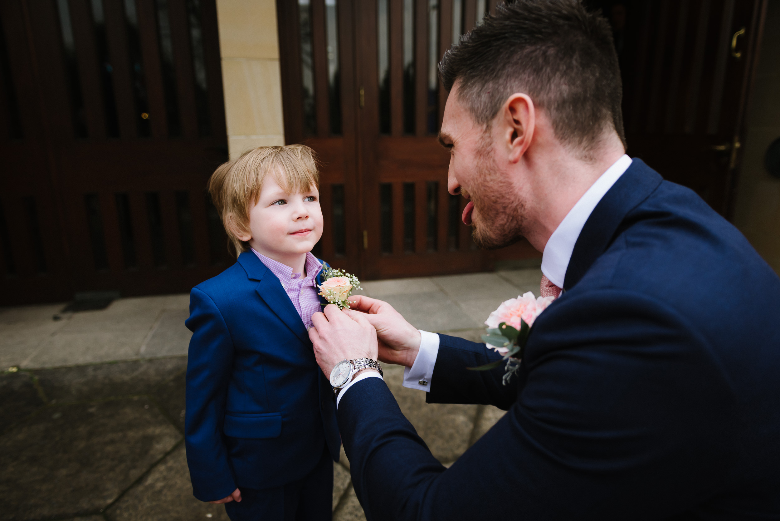 Groom putting button hole on his nephew