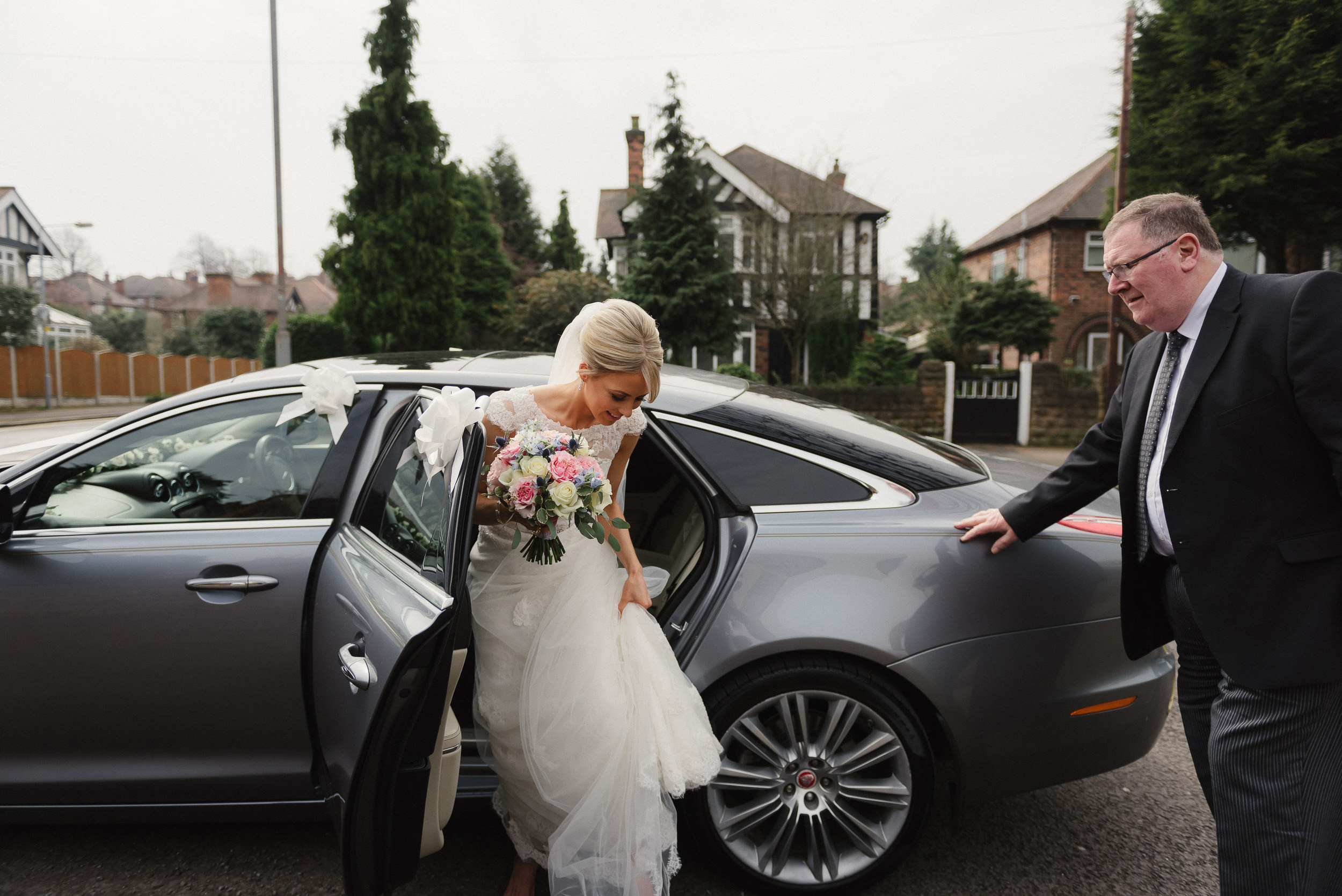 Bride getting out of her wedding car