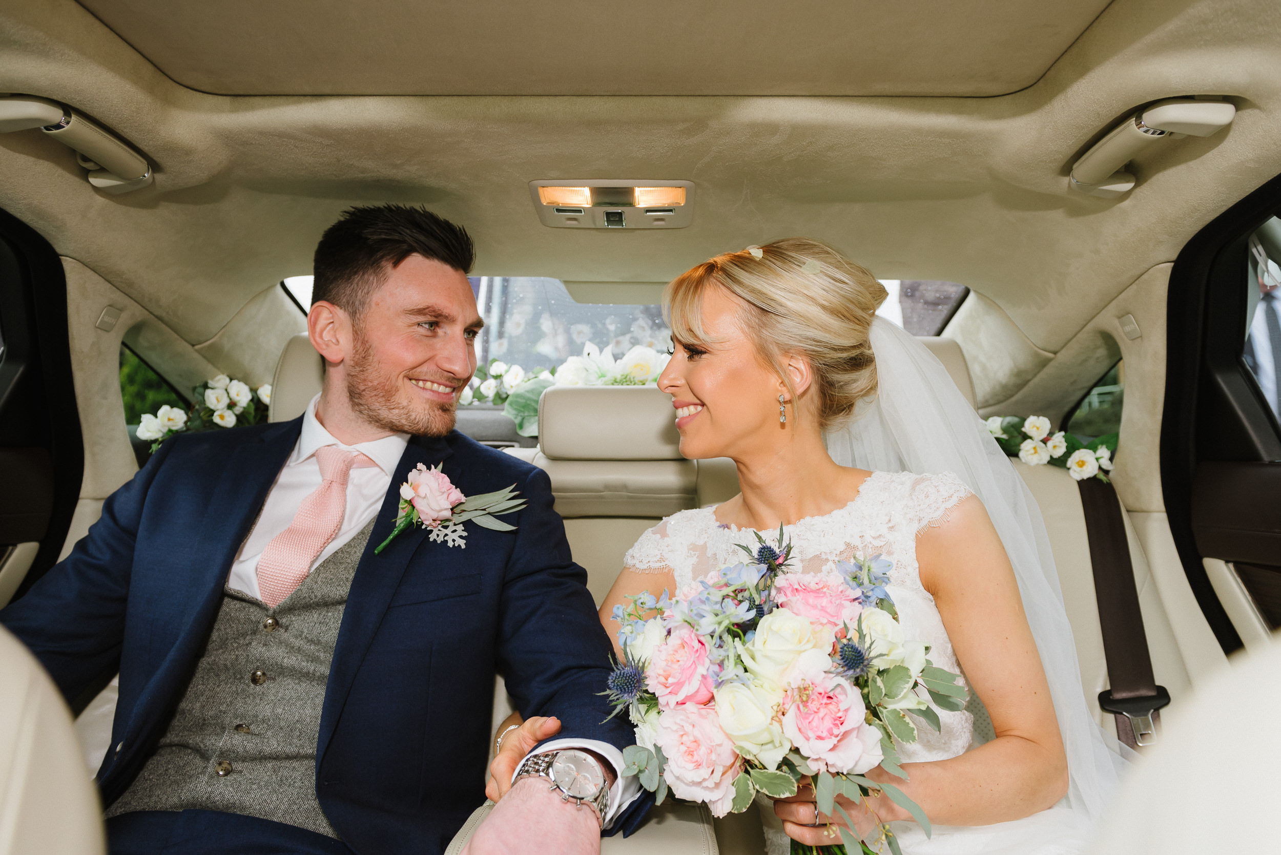 bride and groom in their wedding car