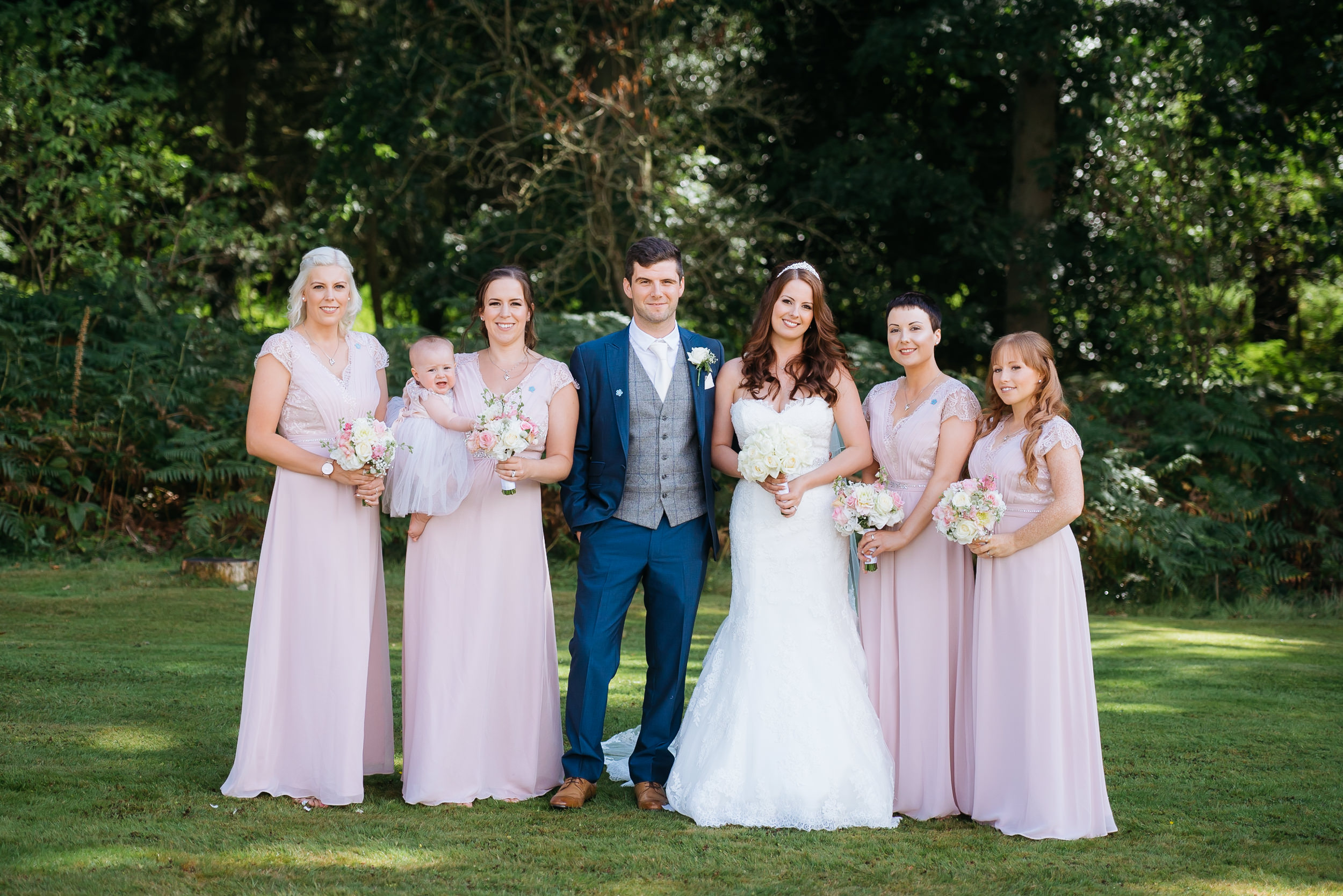 photogarph of the bride and groom with her bridesmaids