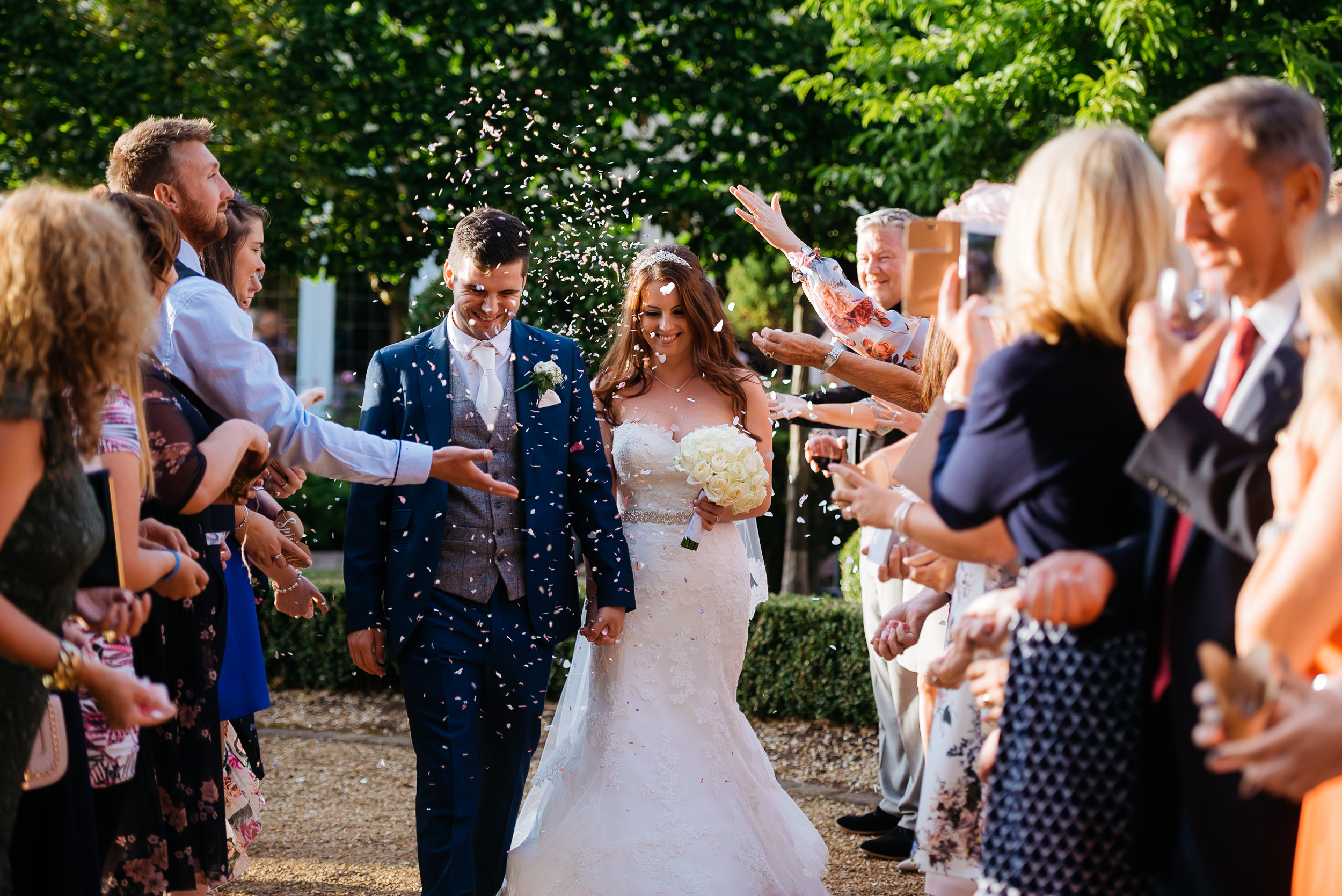 wedding guests throwing confetti on the bride and groom at the Hogarths Hotel