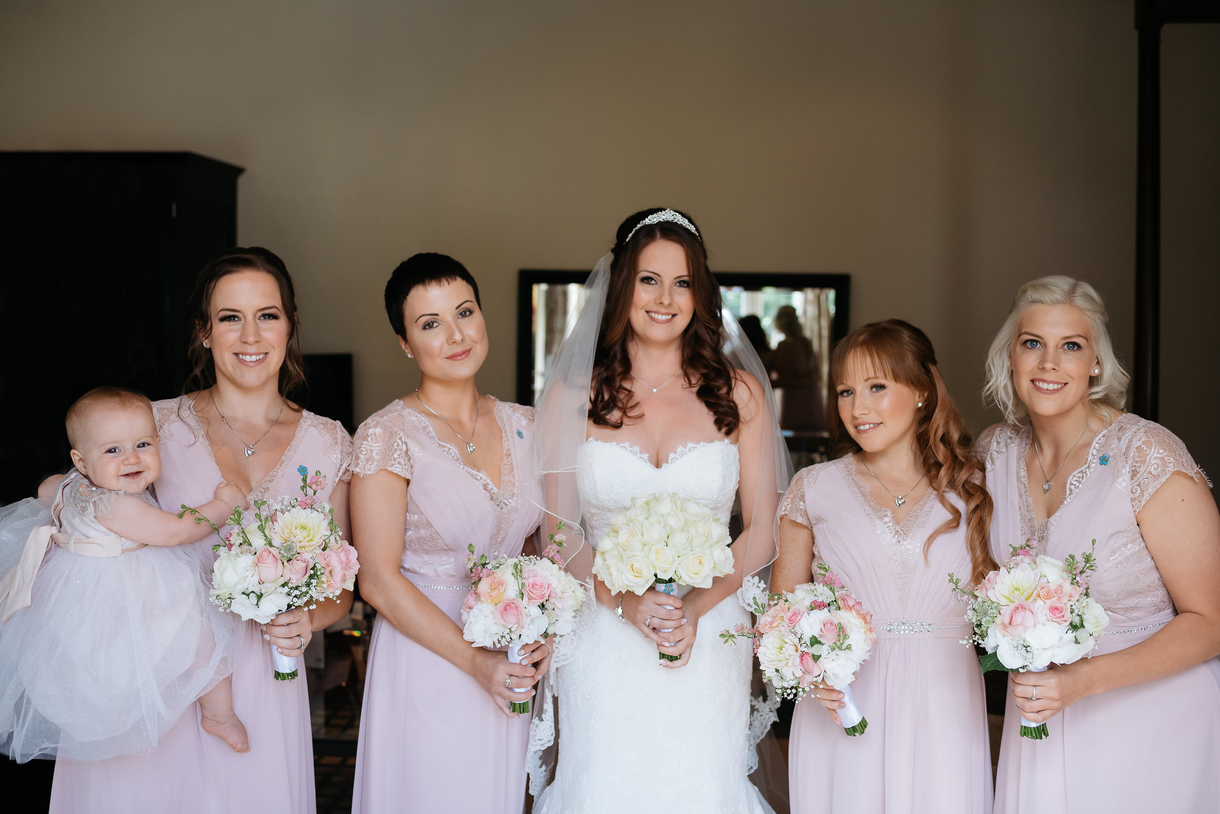 bride and bridesmaids posing for a photograph