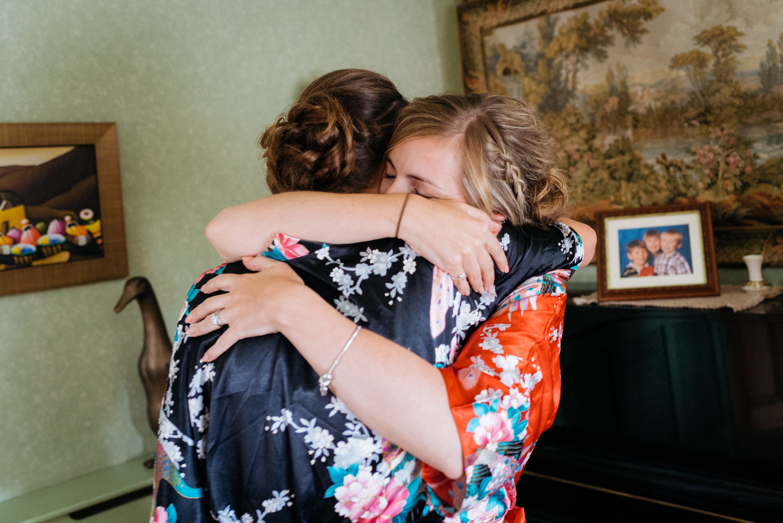 Bride and her maid of honour hugging