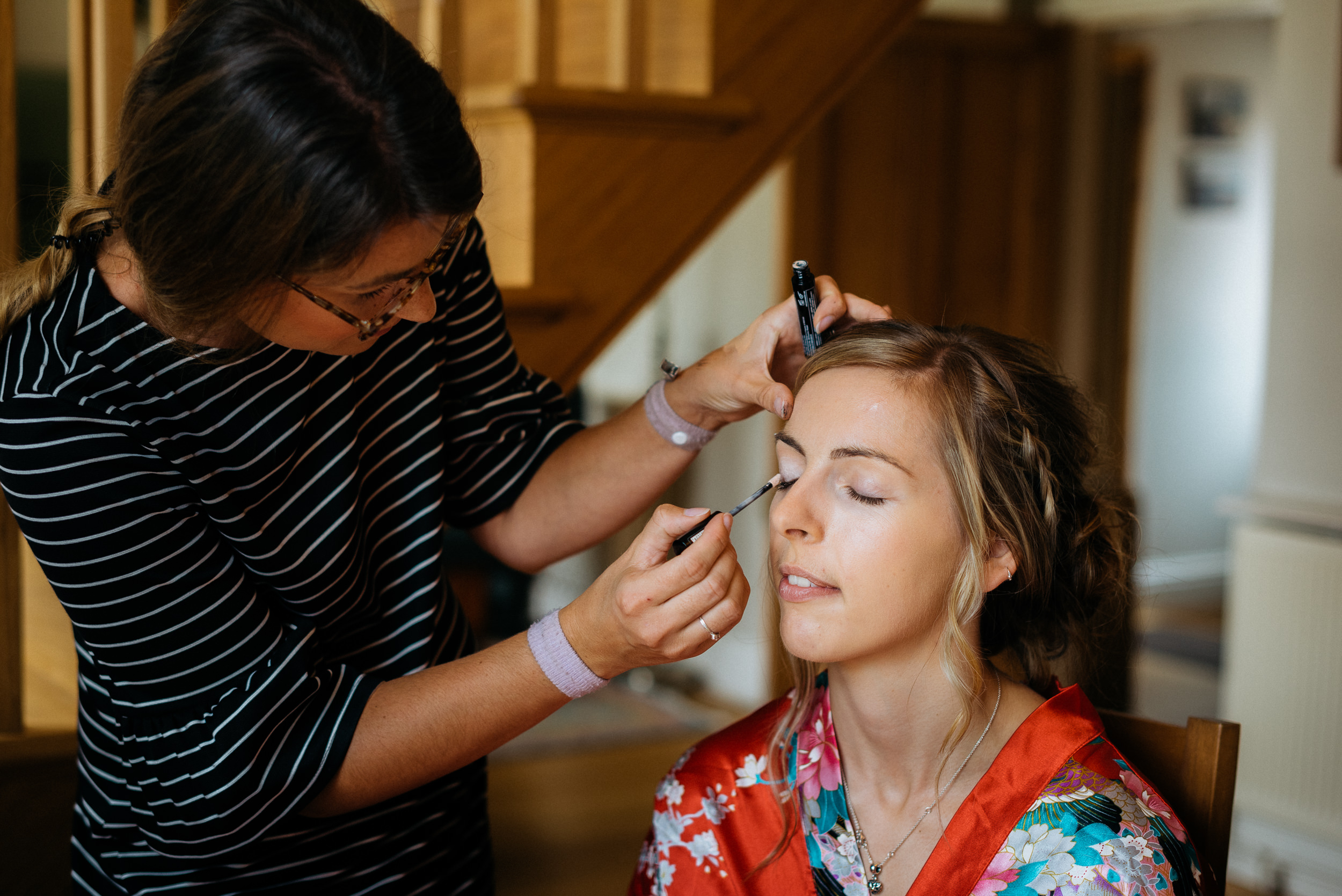 bride getting her wedding makeup applied