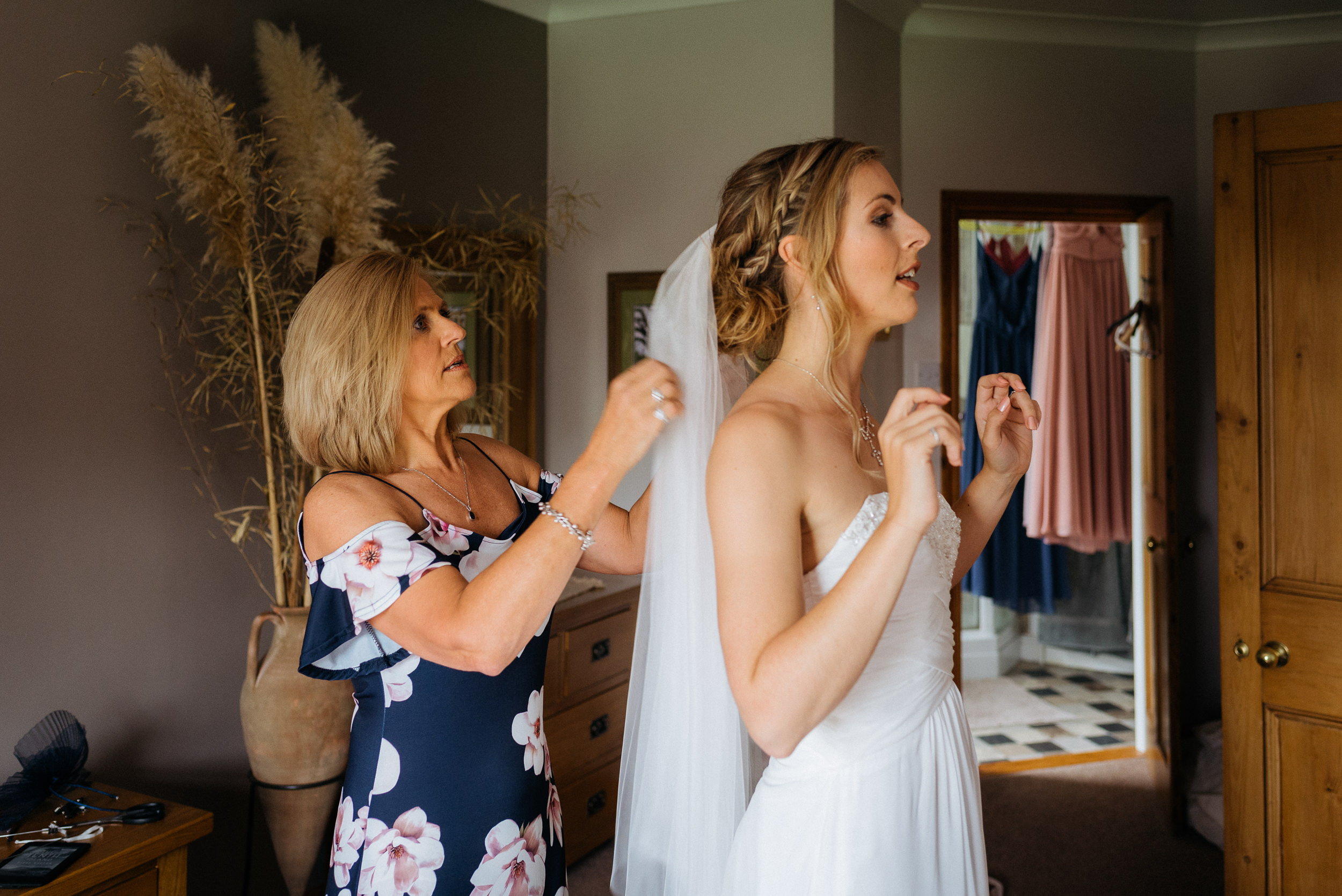 Brides mother adjusting the brides veil