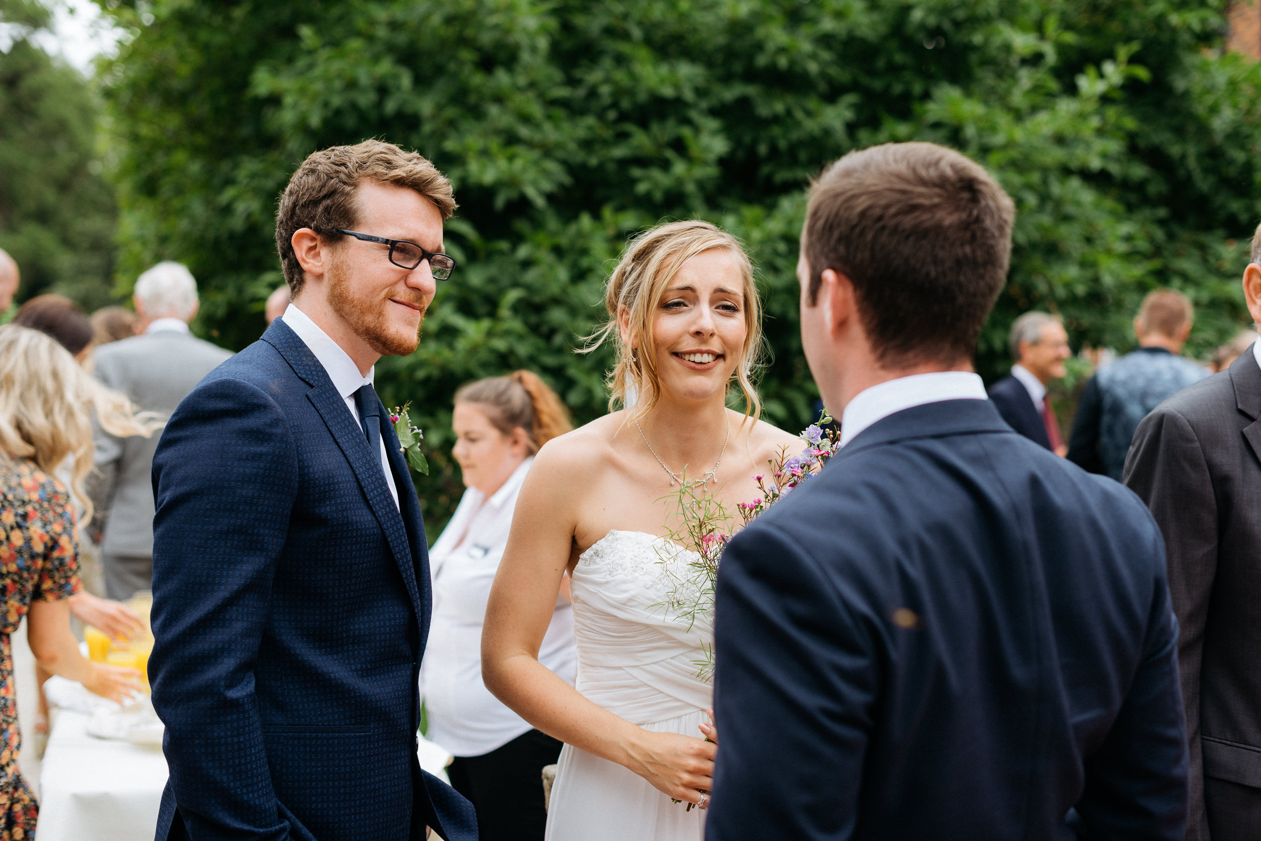 Bride and groom talking with their friends at the wedding