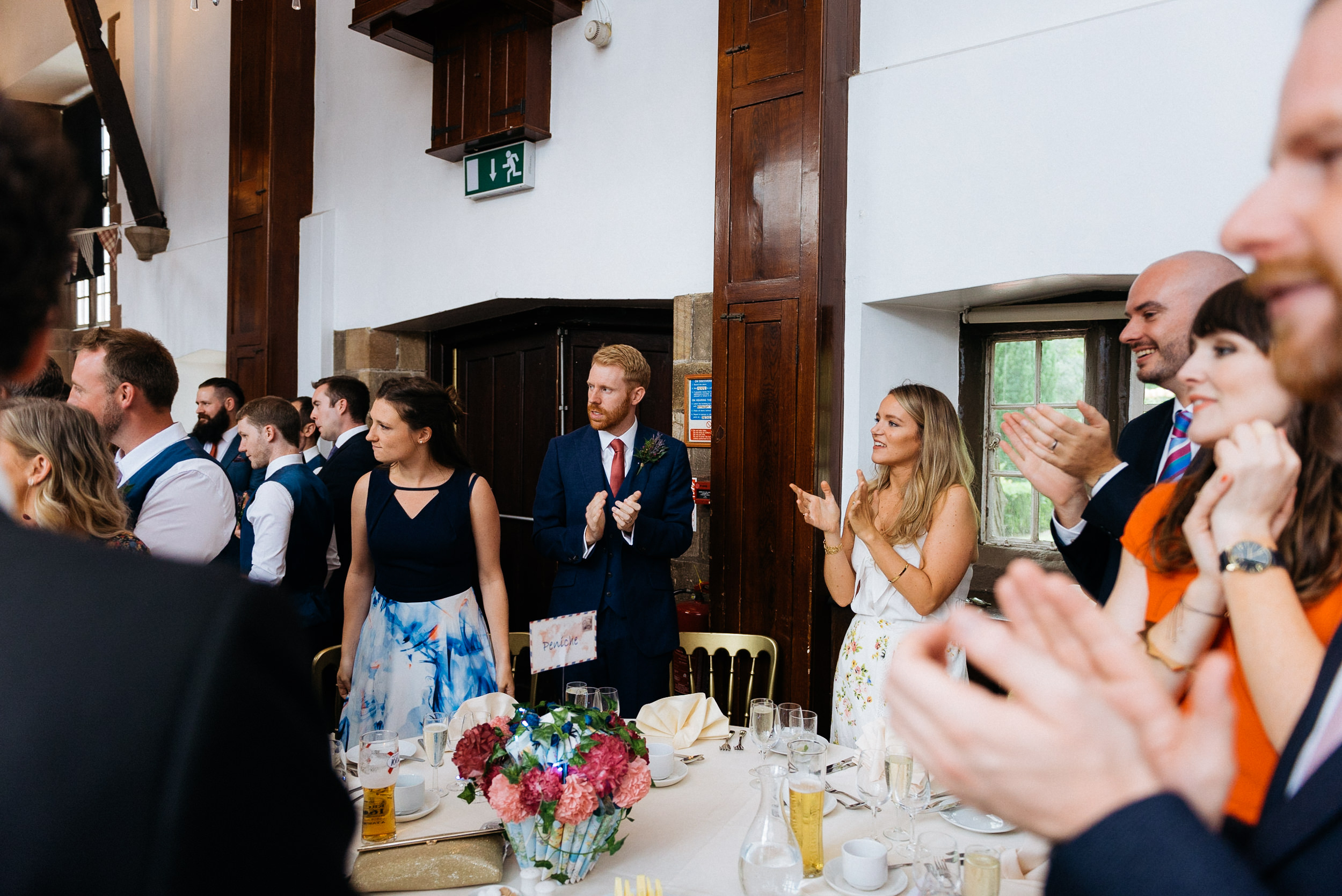 wedding guests stand for the arrival of the bride and groom