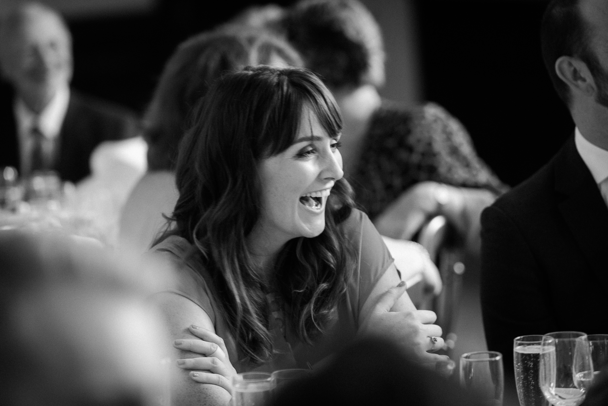 girl laughing at the wedding specches