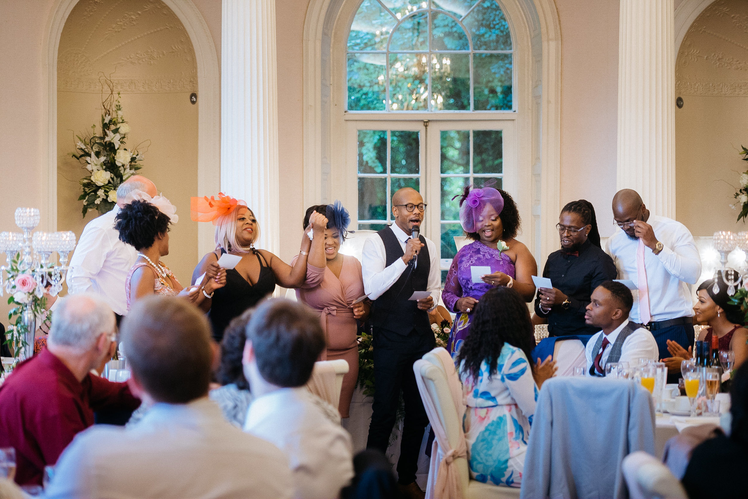 African wedding guests sing to the bride