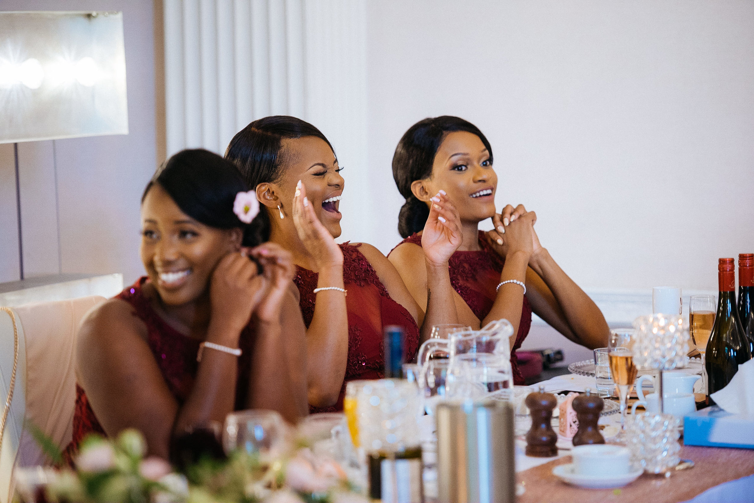 Bridesmaids laughing at the wedding speeches at Colwick Hall