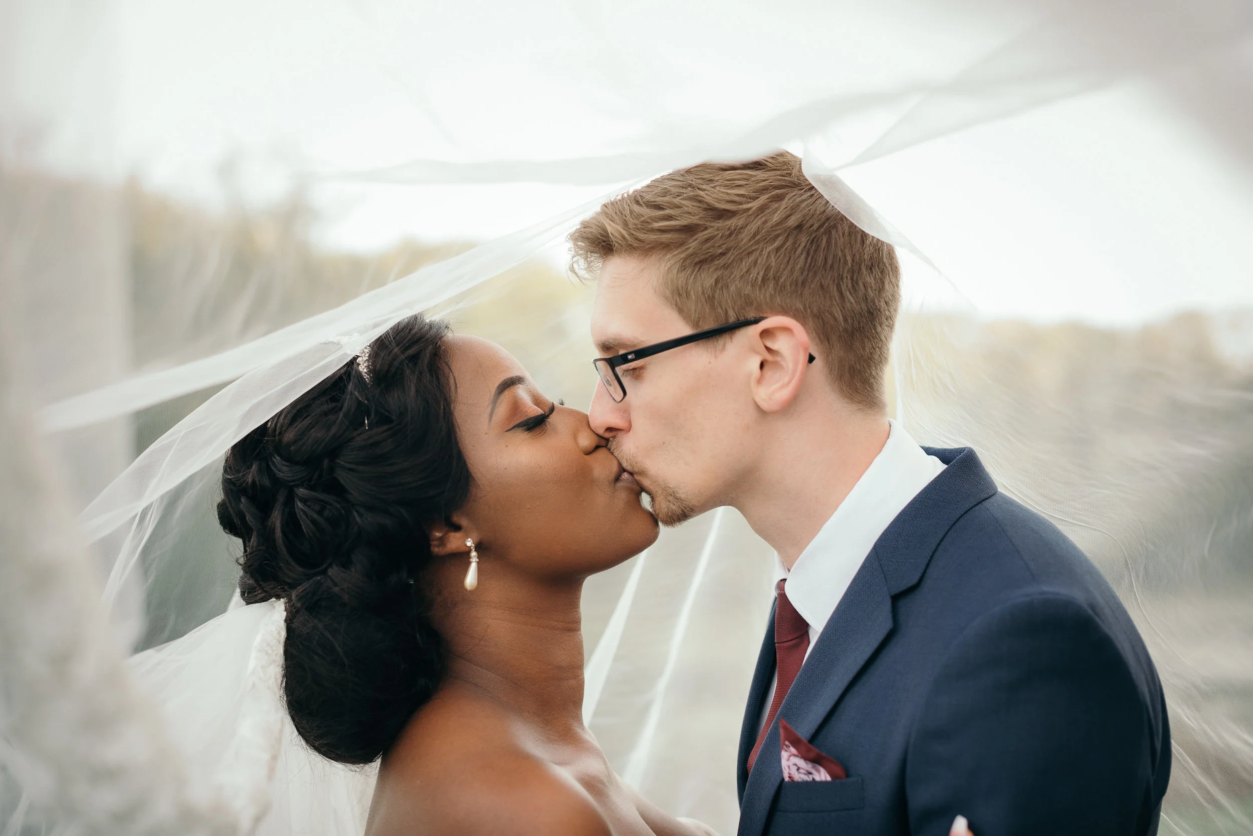 Groom kisses his bride on the lips at their Colwick Hall wedding