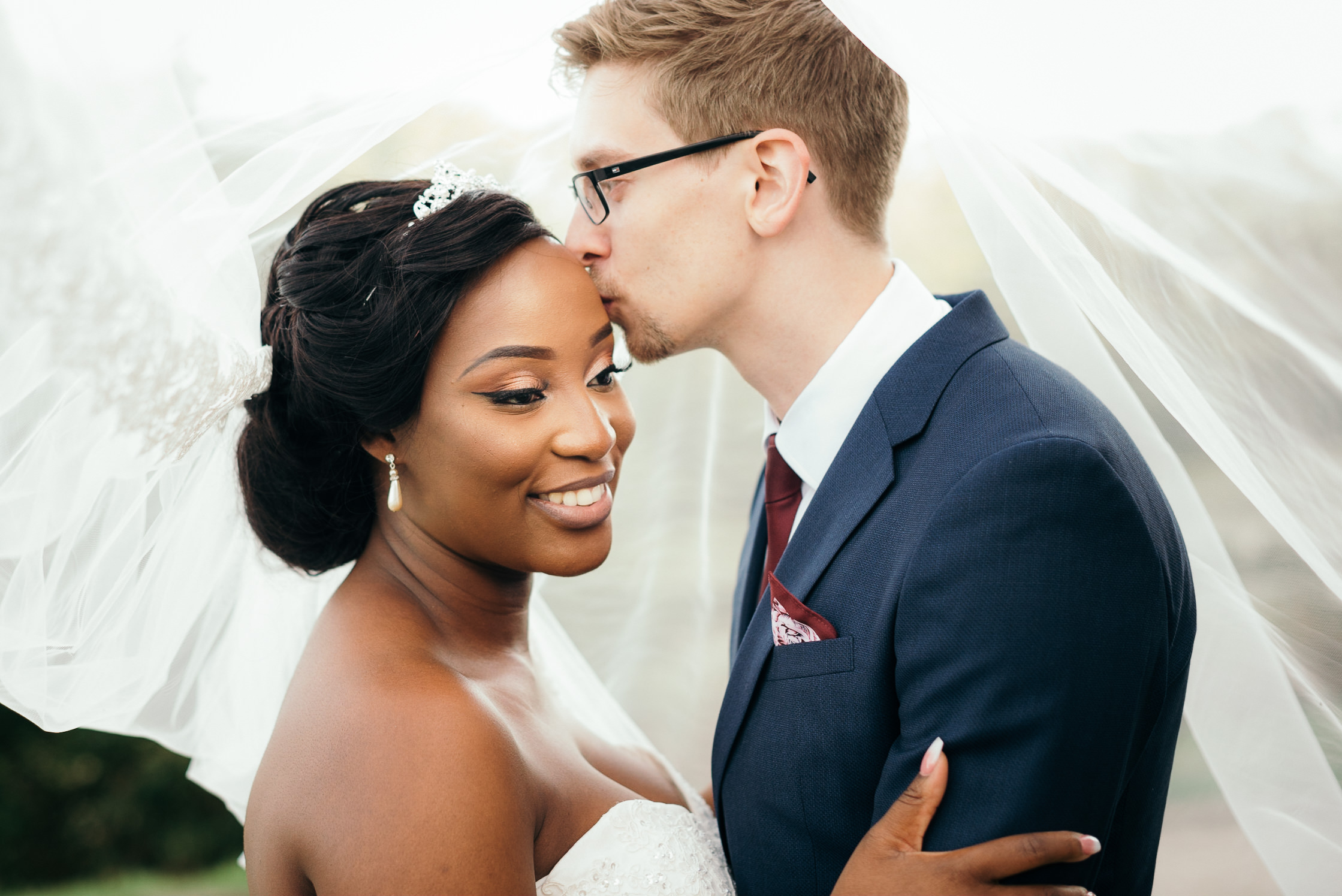 The groom kissing his wife on the fore head on their Colwick Hall wedding