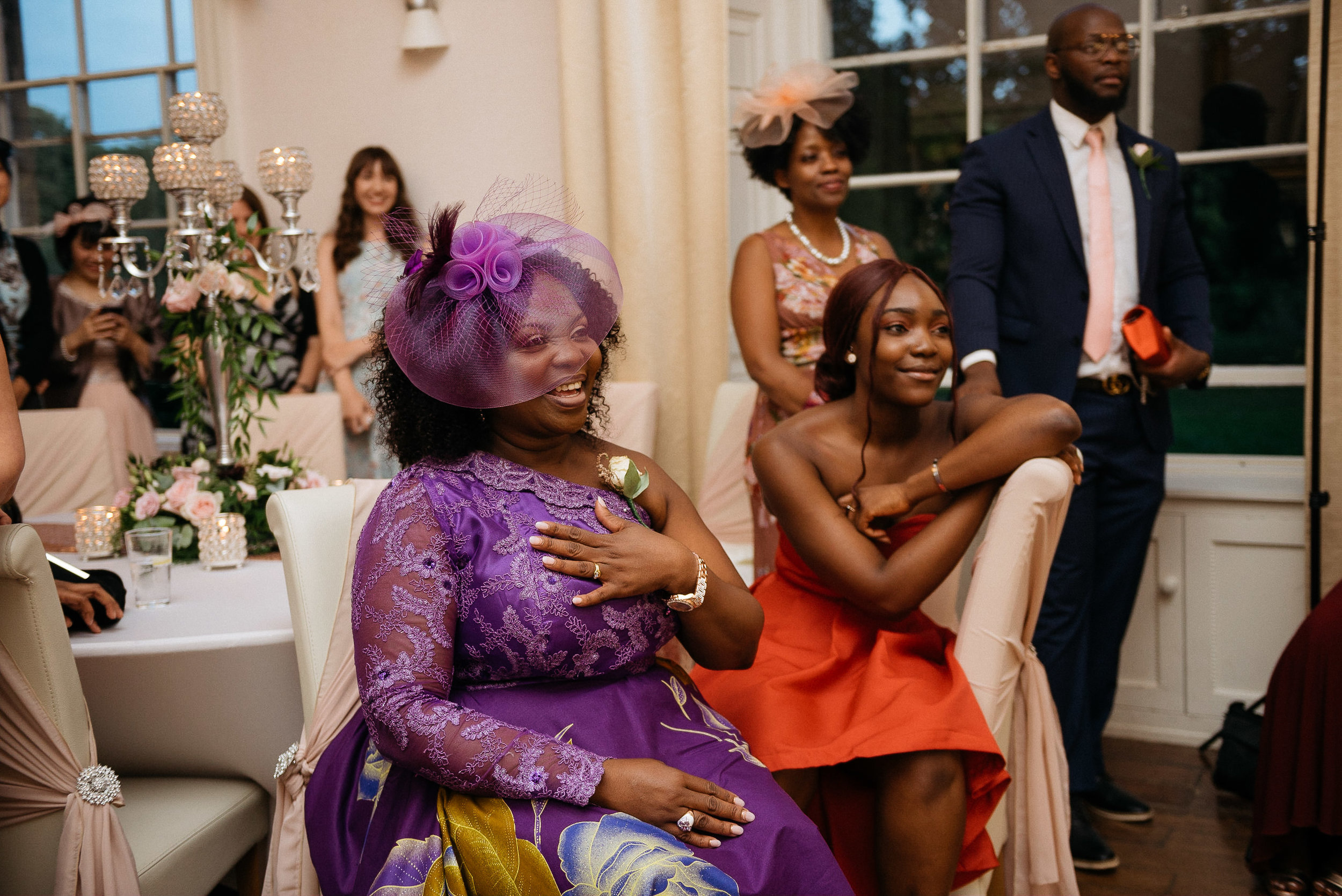 mother of the bride watches as the bride dances