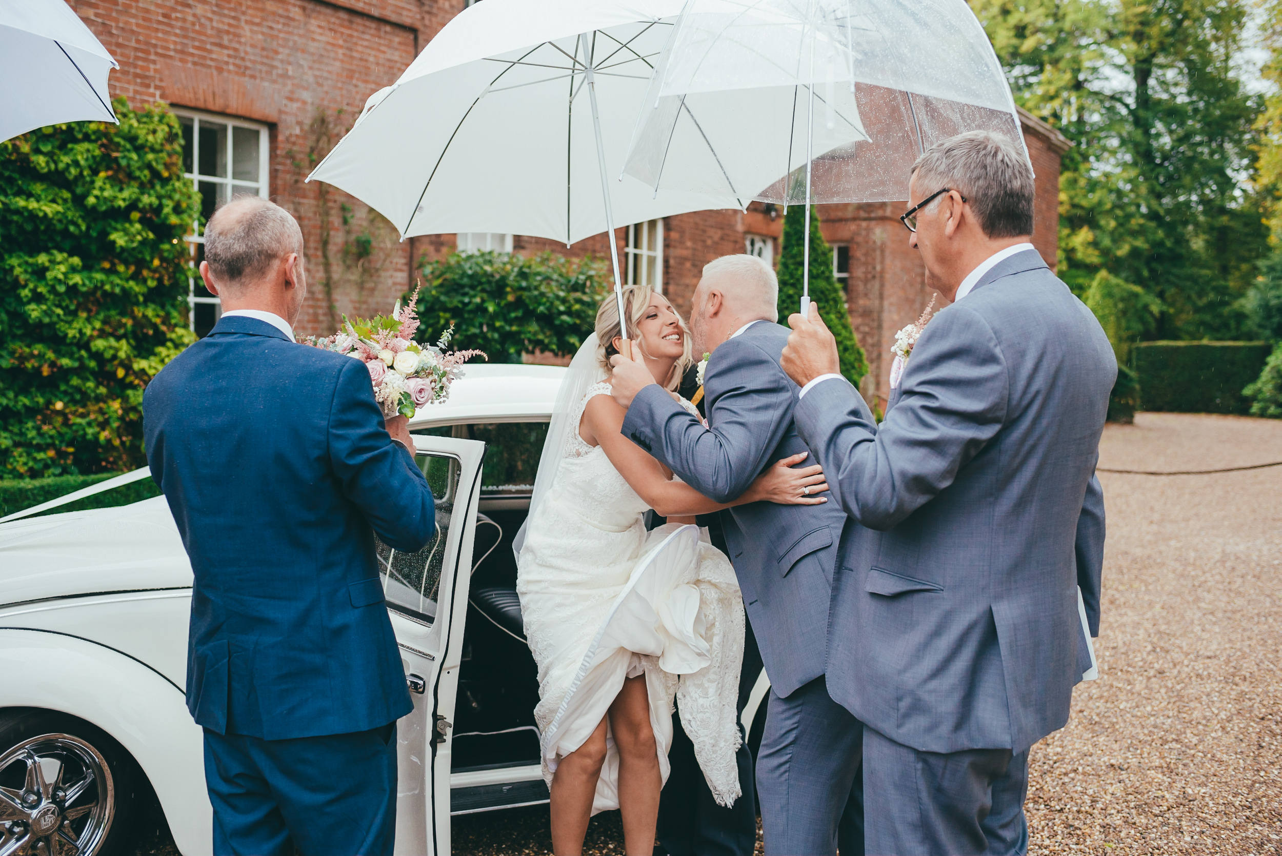 Keeping the bride dry under an umbrella