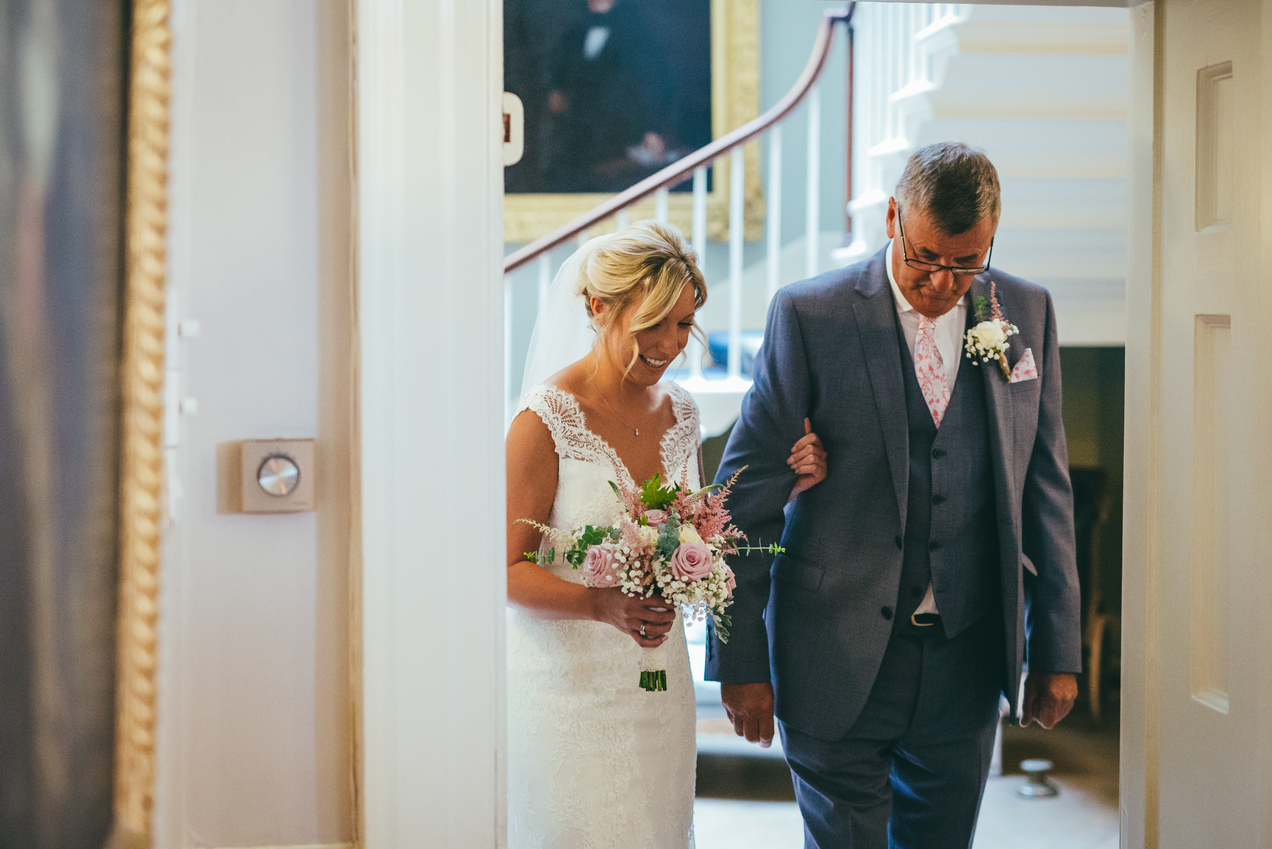 bride and her father walking into the ceremony room