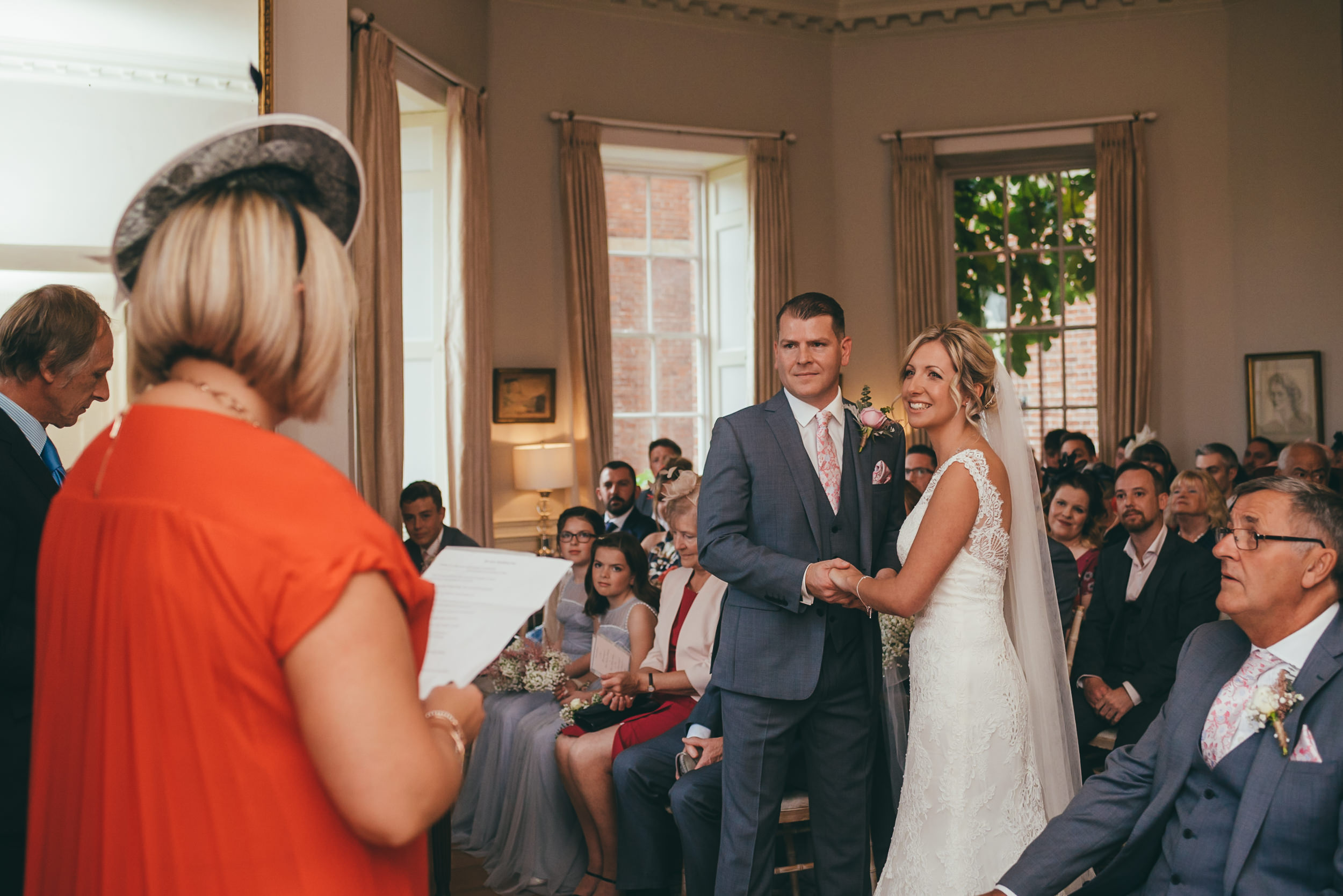 Bride and groom listening to a reading